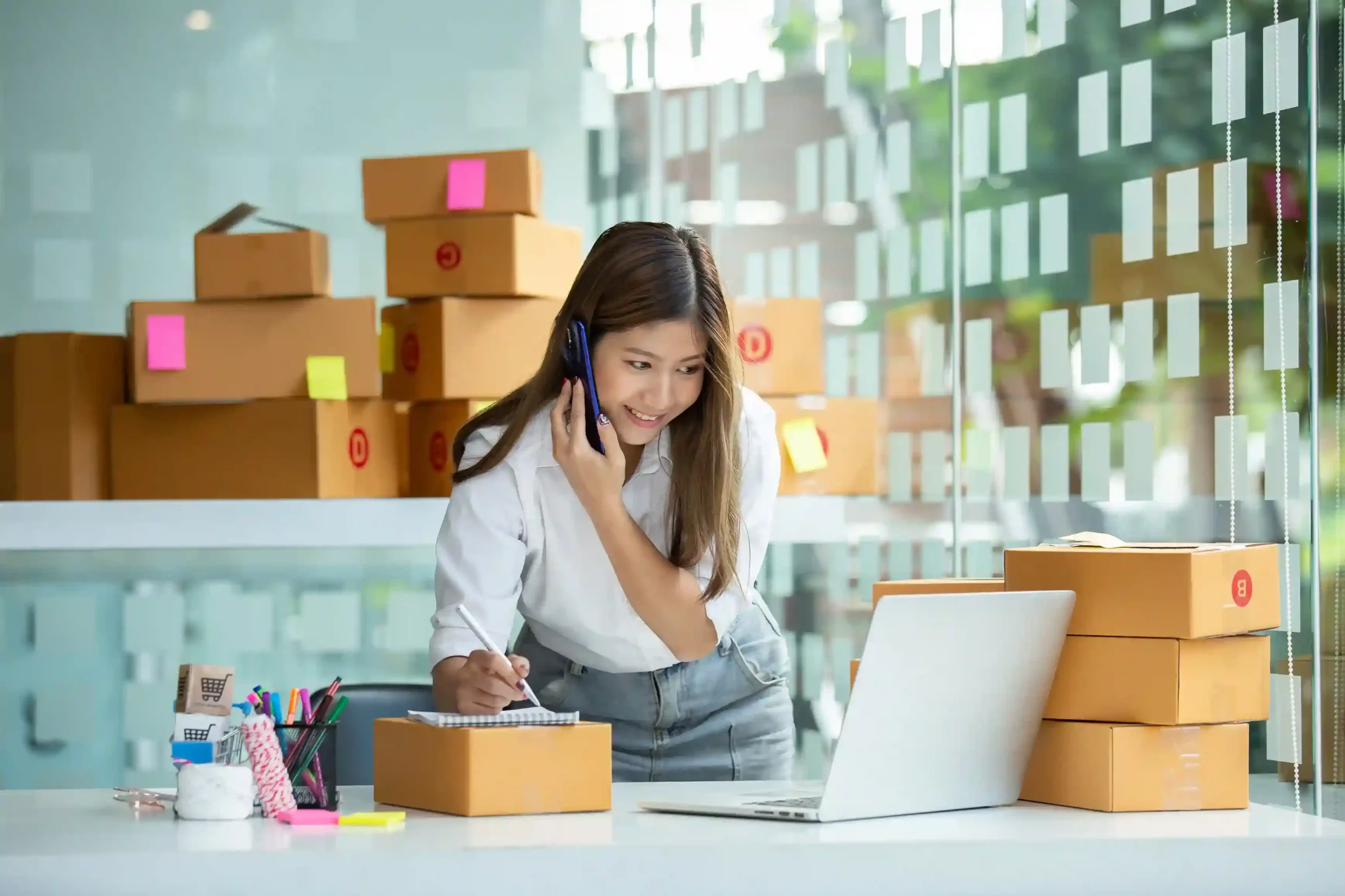 Indosoft reseller using the Partner Program on a mobile device to track and pack customer orders. Small business owner and Indosoft reseller checking purchase orders and packing products for customers