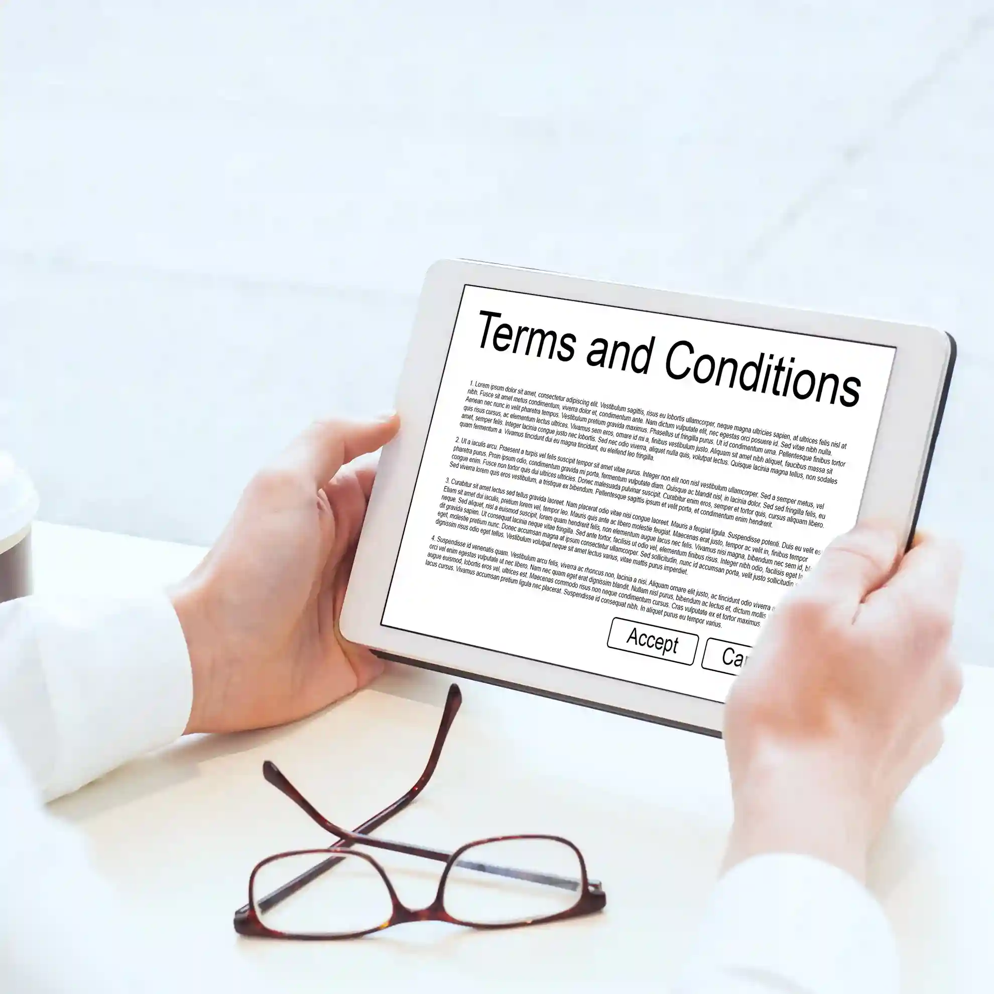 Customer reviews Indosoft terms on a tablet, confirming understanding with support. Person reviewing Indosoft Terms & Conditions on a tablet, preparing questions for support.