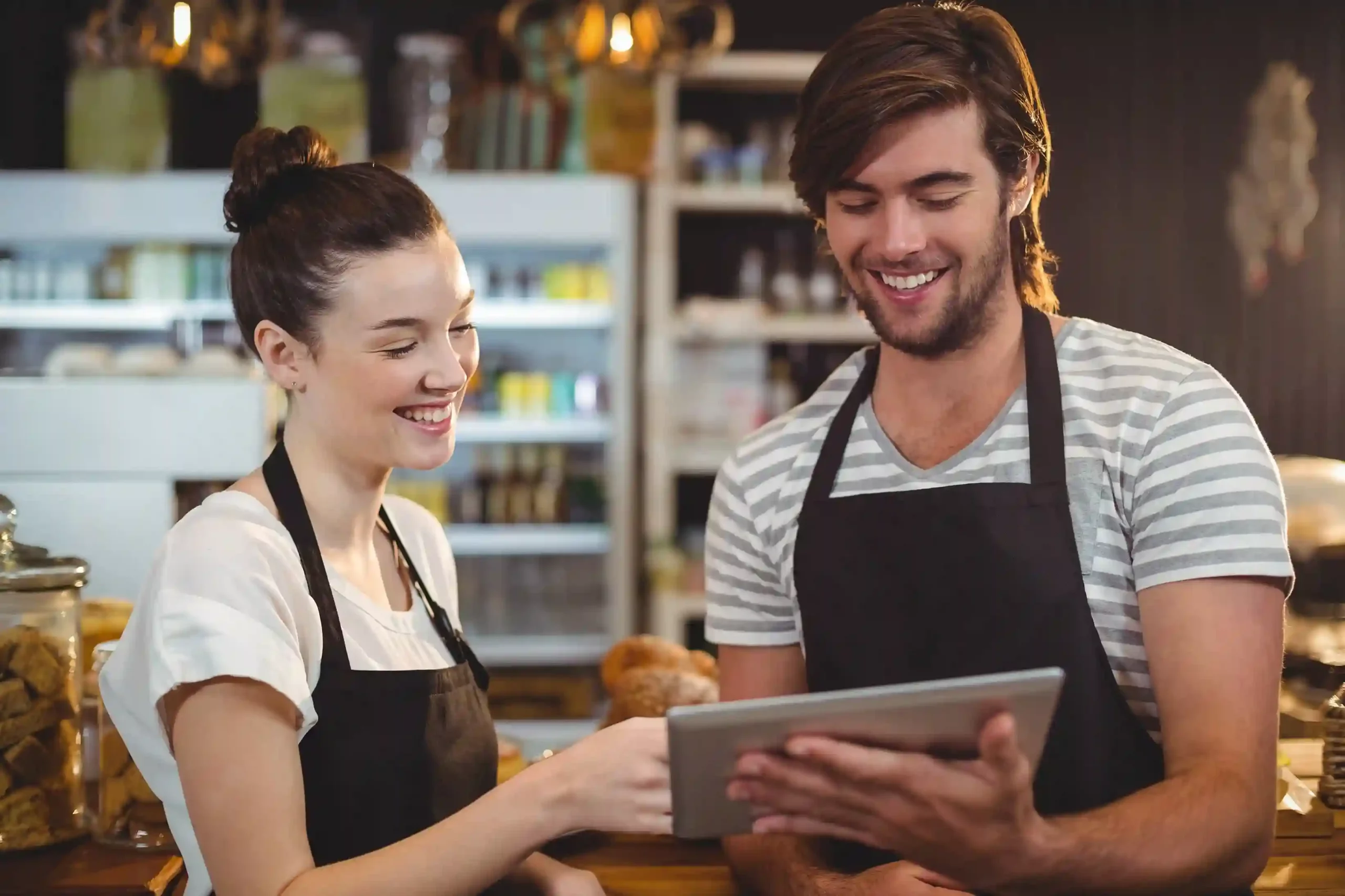 Waiter and waitress using Indosoft’s smart hospitality platform on a tablet to deliver personalized guest experiences. Restaurant staff reviewing digital orders on a tablet using Indosoft Hospitality to enhance guest service and streamline operations.