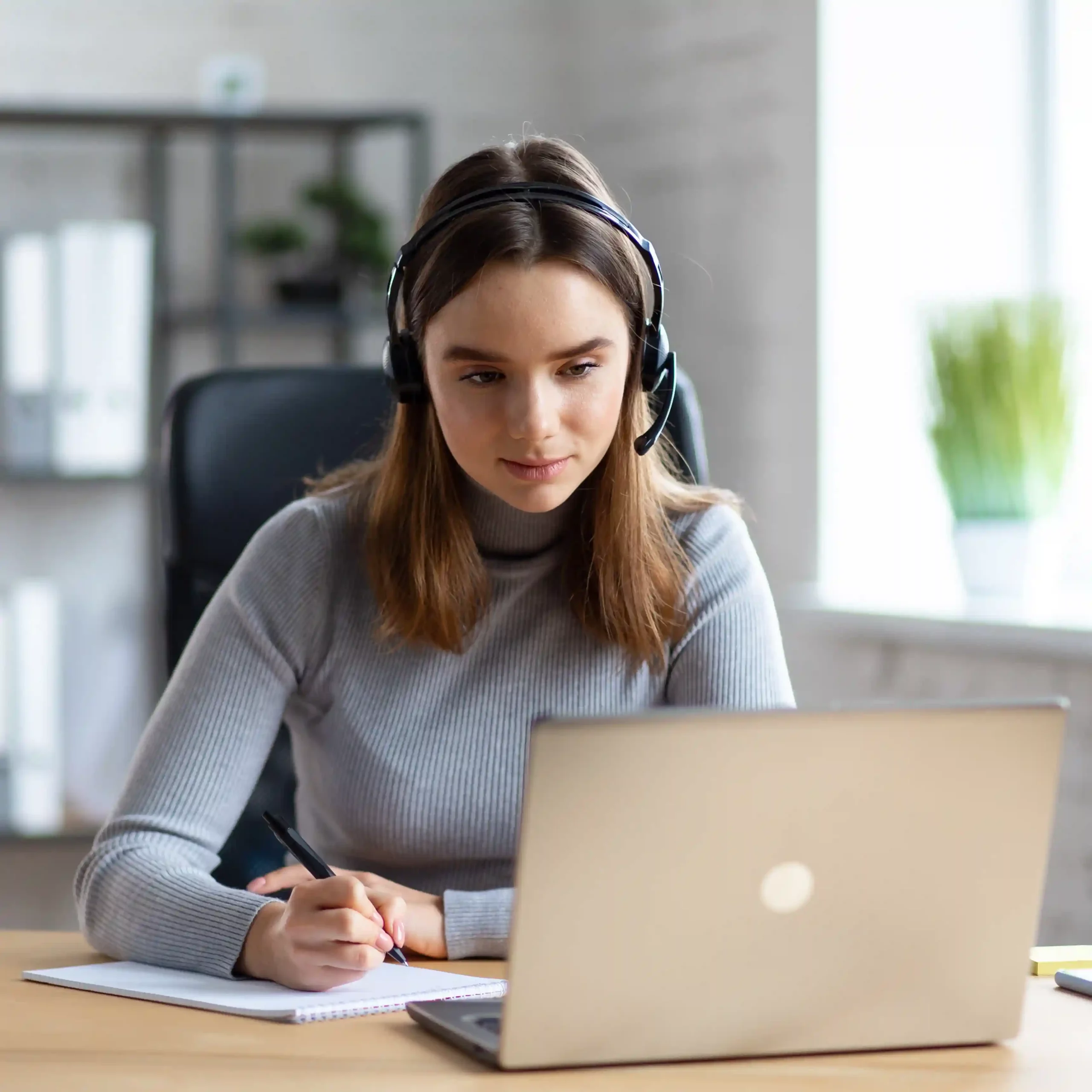Student learning online with laptop and notebook, showcasing how Indosoft enhances campus communication. Student learning online with laptop and notebook, showcasing how Indosoft enhances campus communication.