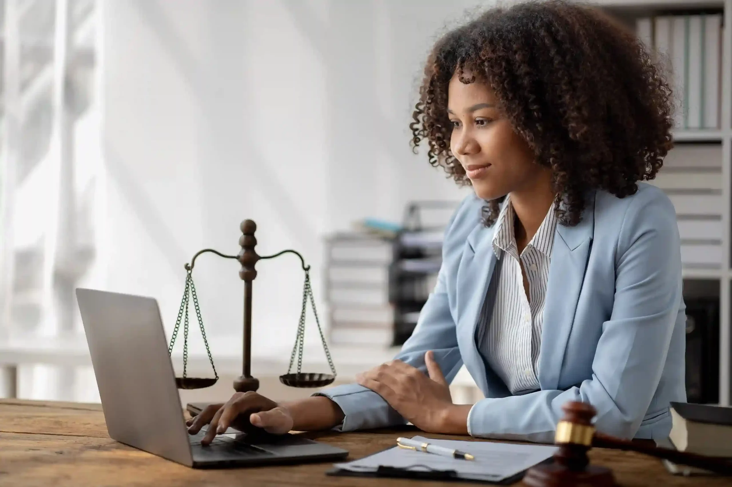 Female legal professional collaborates with her client via Indosoft’s digital legal solution, streamlining communication and case management. A female attorney uses her laptop to connect with a client through Indosoft’s legal solution, collaborating seamlessly on case documents and updates.