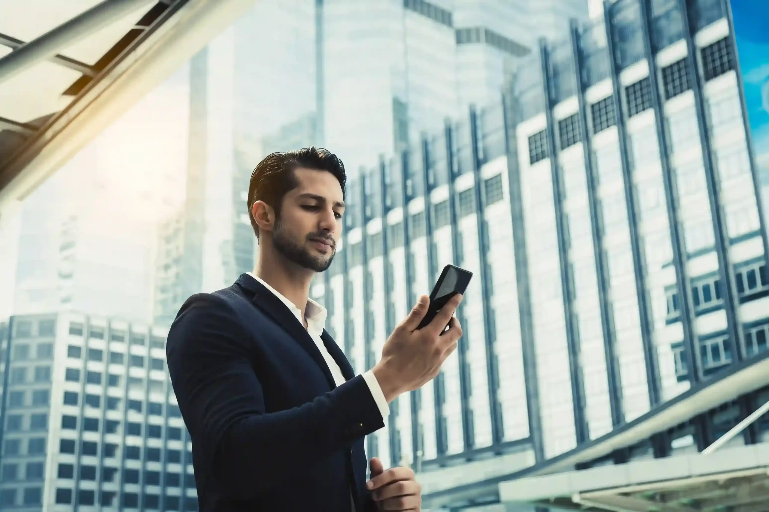 A team member reviews active conversations on his phone while on the move, relying on Indosoft to show which interactions he owns and still needs to close. A professional checks conversation updates on his phone outside the office, confidently knowing Indosoft assigns clear ownership to open customer conversations until they are resolved.