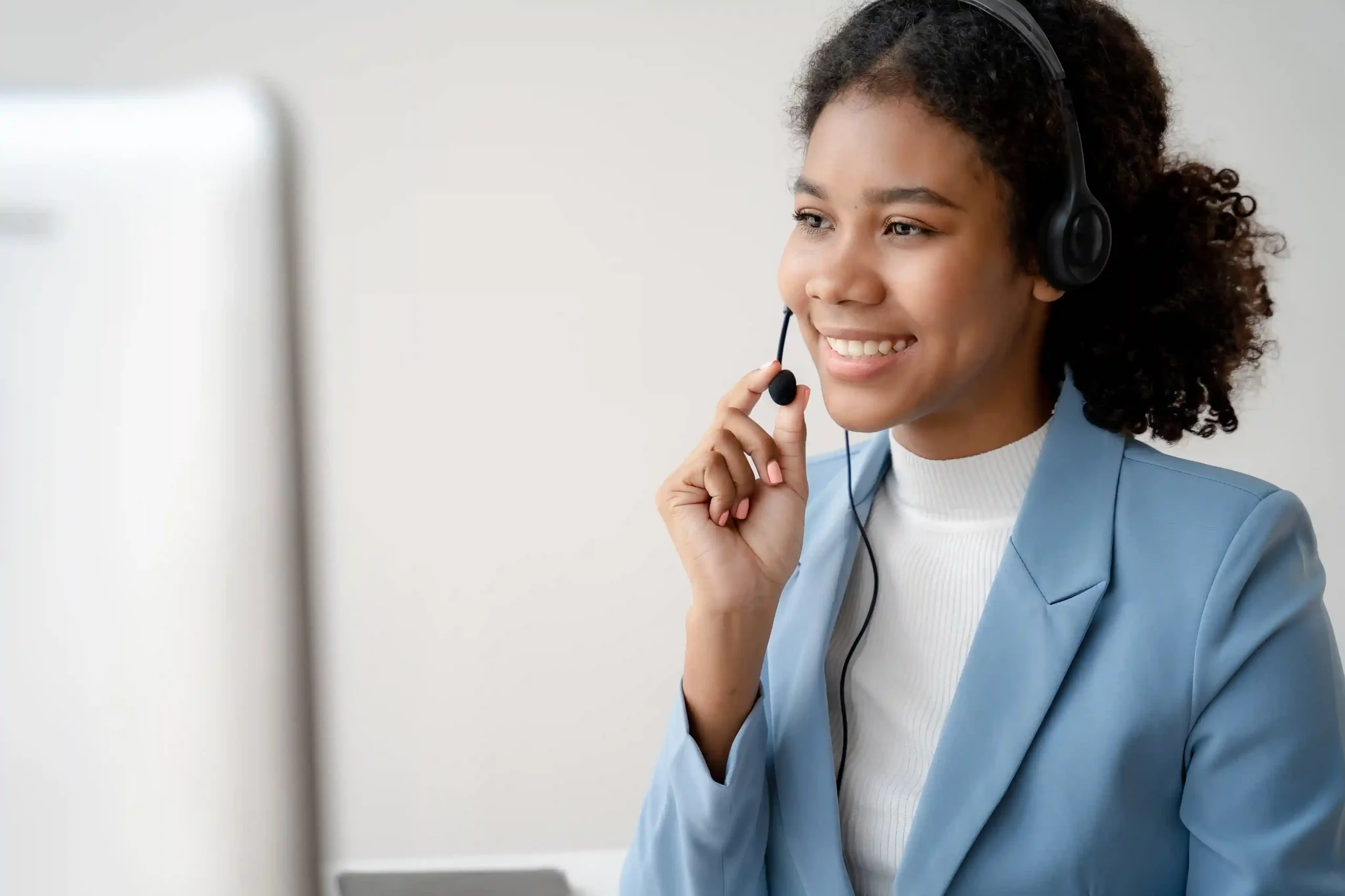 A contact center agent smiles while preparing her next task, reflecting how Indosoft removes the burden of repetitive voicemail recording and helps her move efficiently through outbound work An outbound agent confidently manages her headset and screen, showing how Indosoft’s voicemail drop reduces repetitive voicemail tasks and frees her to focus on active conversations