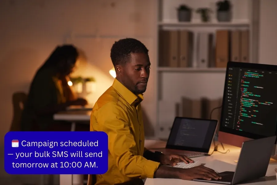 A developer reviews his screen while configuring Indosoft’s automation features for recurring MMS reminders and notifications. Employee working late on a computer while scheduling bulk MMS campaigns through Indosoft.