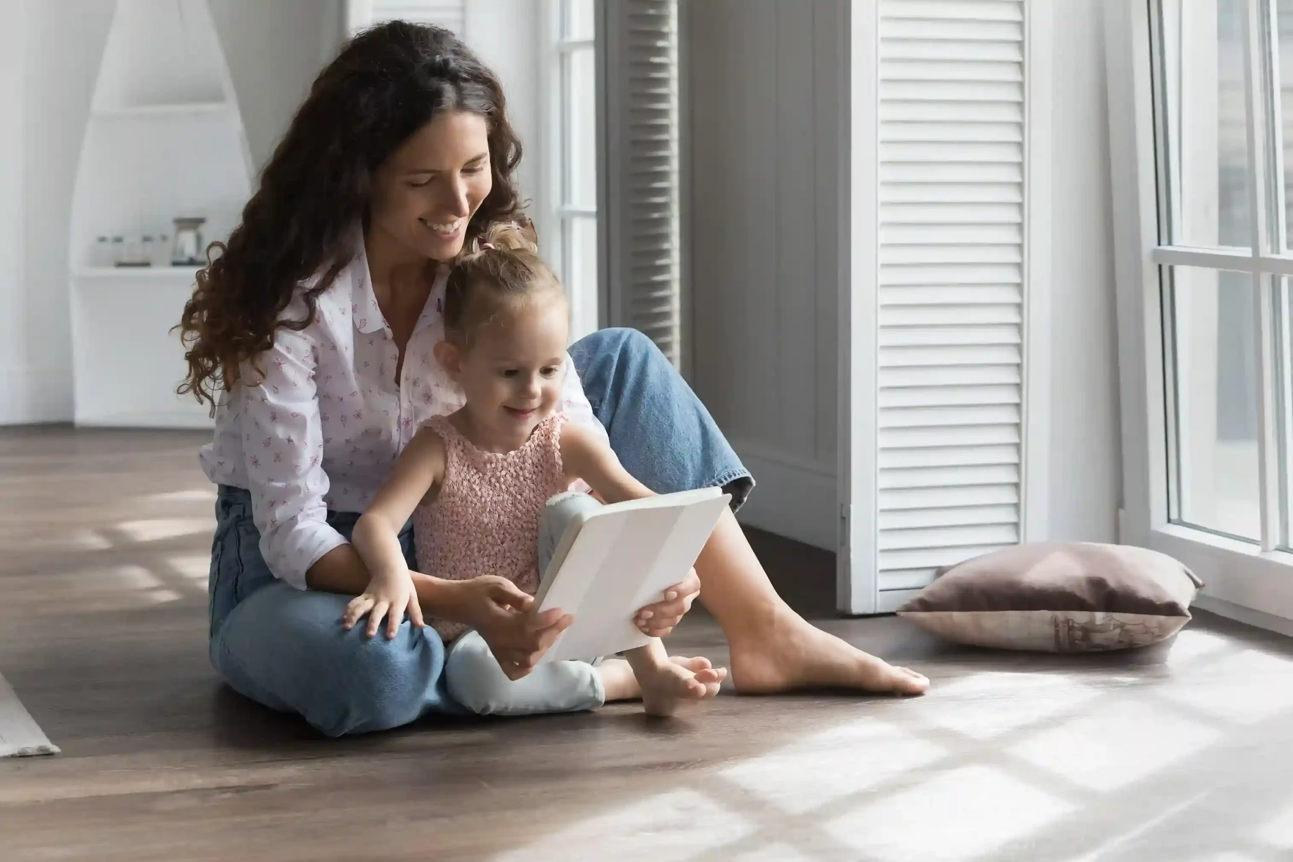 While managing a call from home, a mother uses mute to handle a moment of distraction, maintaining a seamless conversation regardless of the call type. A parent briefly mutes an active call while attending to her child at home, then smoothly returns to the conversation without disrupting the flow.