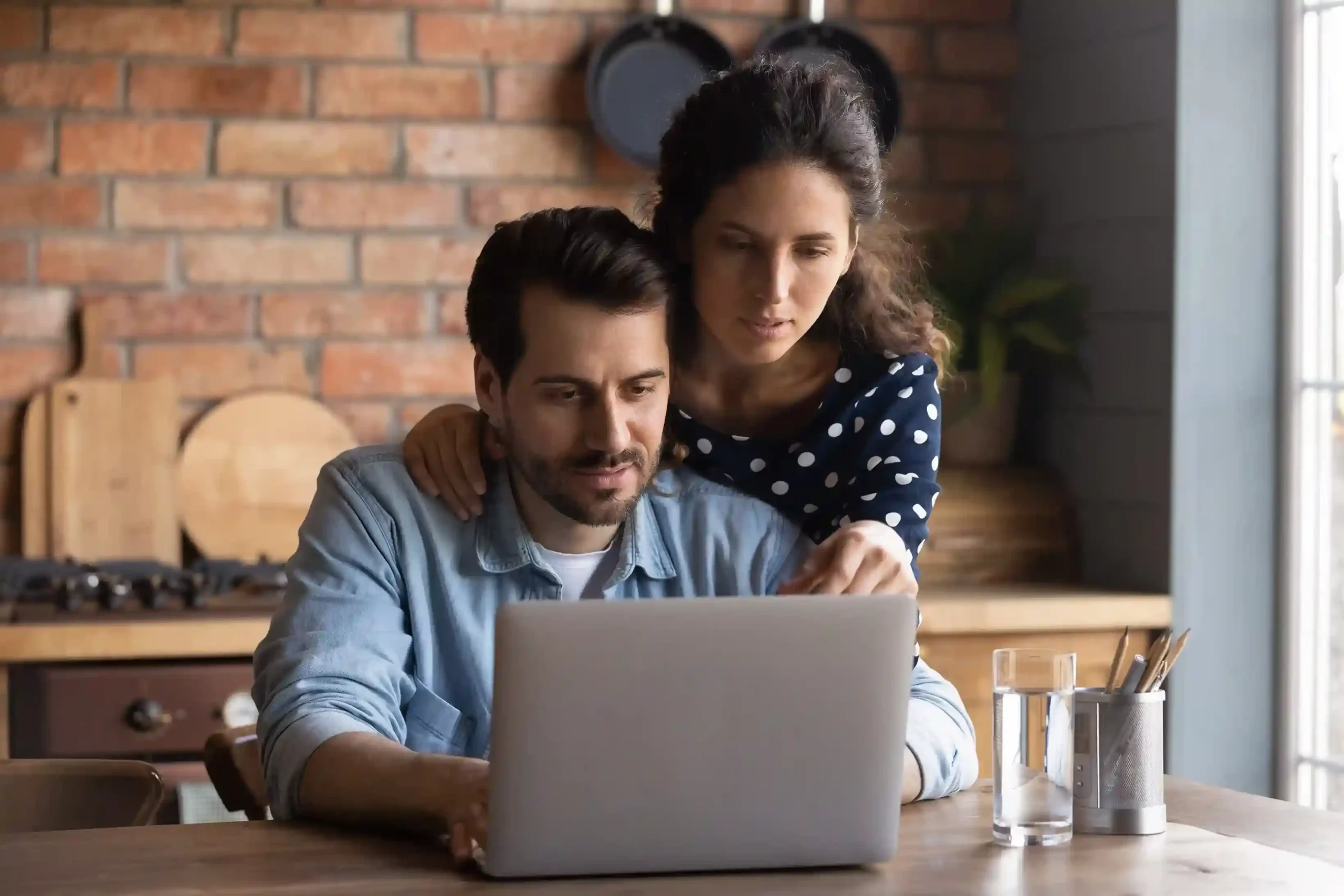 A customer discussion with an insurance agent is reviewed at home, illustrating how call recordings help quality teams evaluate tone, clarity, and overall service delivery. A couple reviews information on a laptop at home after speaking with an insurance agent, reflecting how recorded conversations are later used to evaluate service accuracy and communication quality.