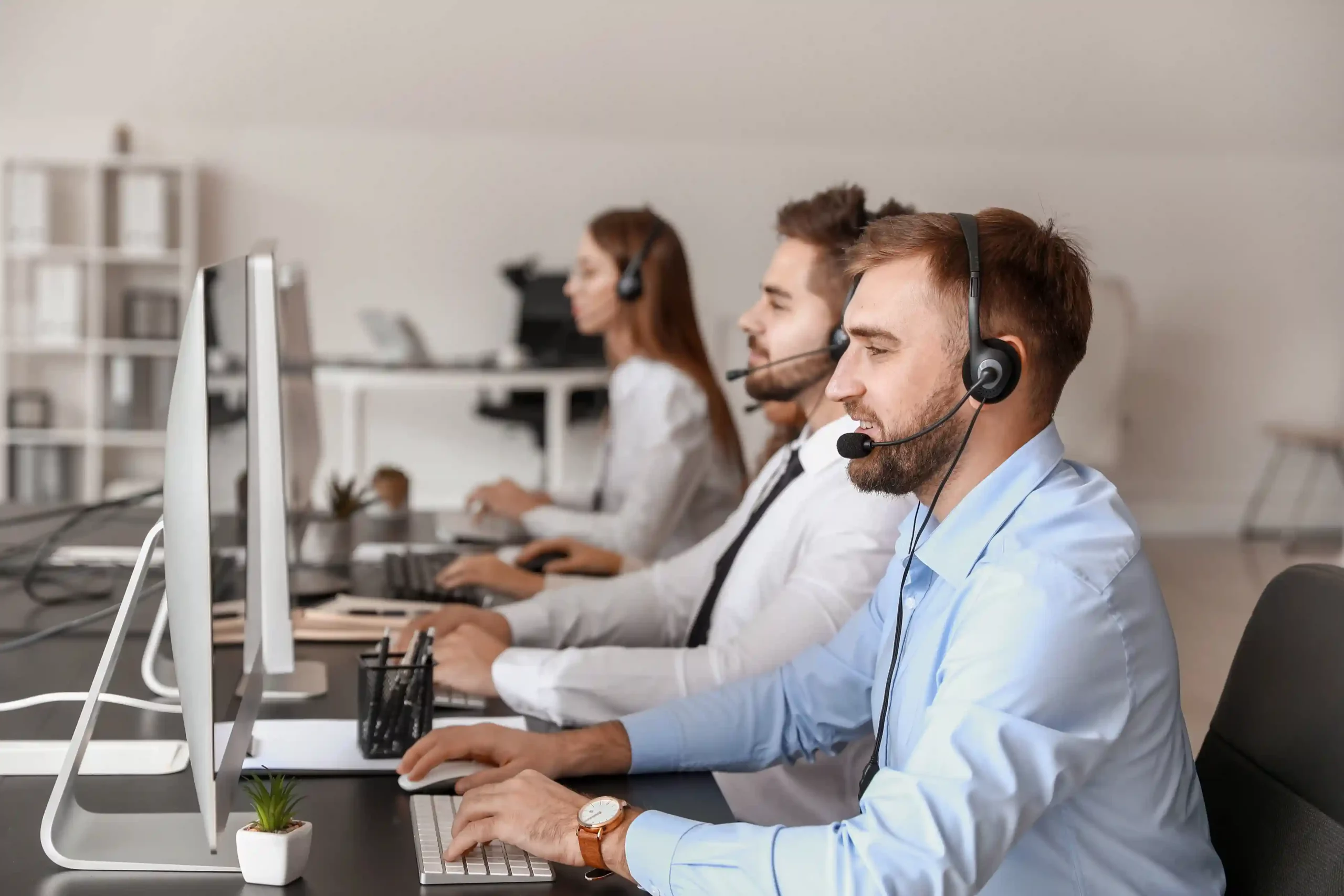 An agent works through customer calls using Indosoft, applying configurable call masking rules to meet compliance requirements. A call center agent manages active calls at his workstation while applying Indosoft call masking rules based on campaign and role.