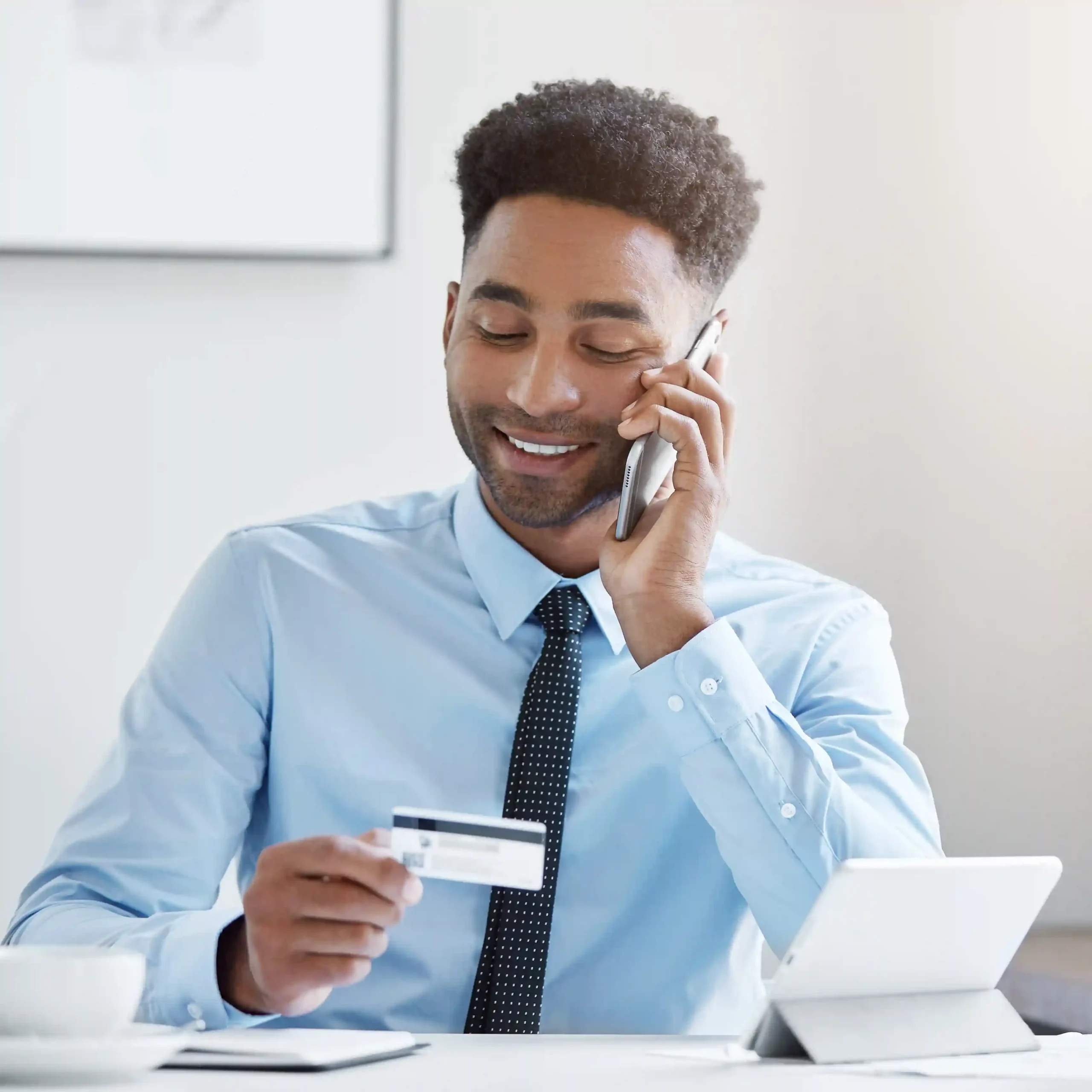 A professional handling a call with confidence, reflecting how Indosoft’s call filtering tools optimize call flow and reduce unnecessary interruptions. A business professional confidently speaking on the phone while reviewing information, representing optimized call flow using Indosoft’s intelligent call filtering.