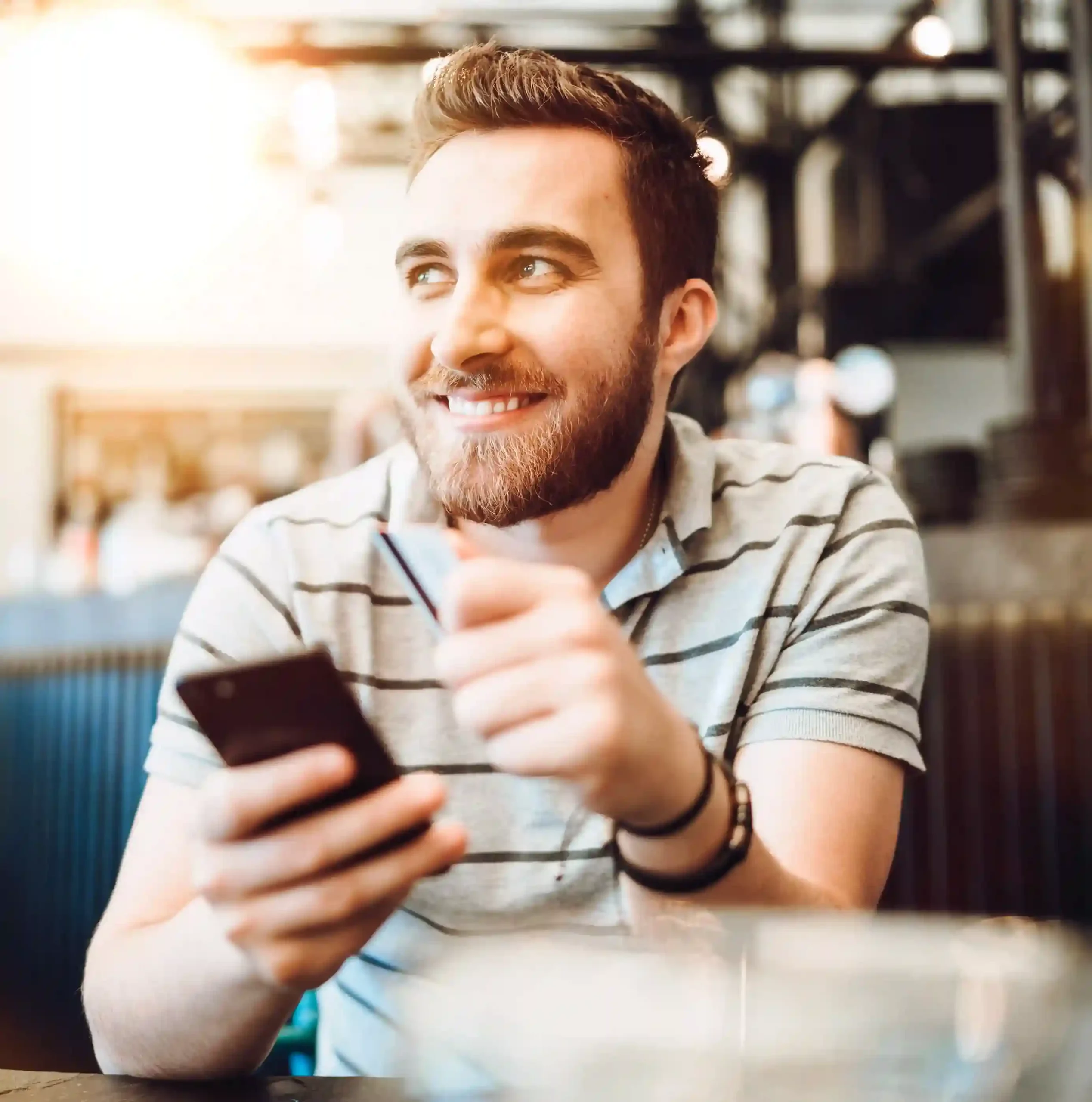 A professional checks his phone with ease, symbolizing how Indosoft makes reviewing call history simple, clear, and reliable. A professional smiles while reviewing call details on his phone, reflecting the confidence teams gain with clear visibility into conversations using Indosoft Call History.