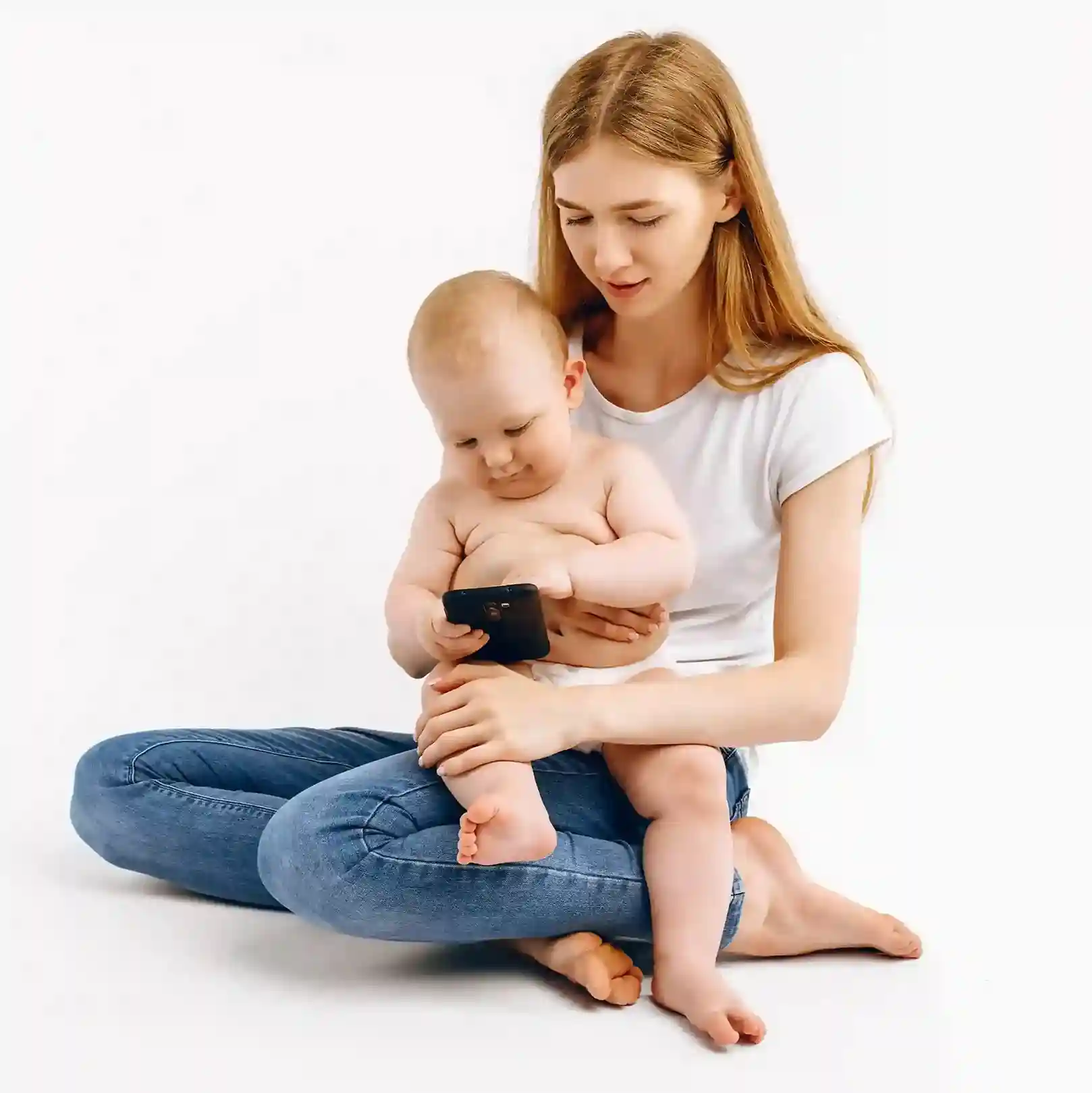 A parent manages a phone with steady attention while caring for a baby, illustrating how Indosoft brings structure and calm to busy call environments. A parent holds a baby while calmly checking a phone, reflecting how structured call queues bring order and reassurance even when demands are high and attention is divided.