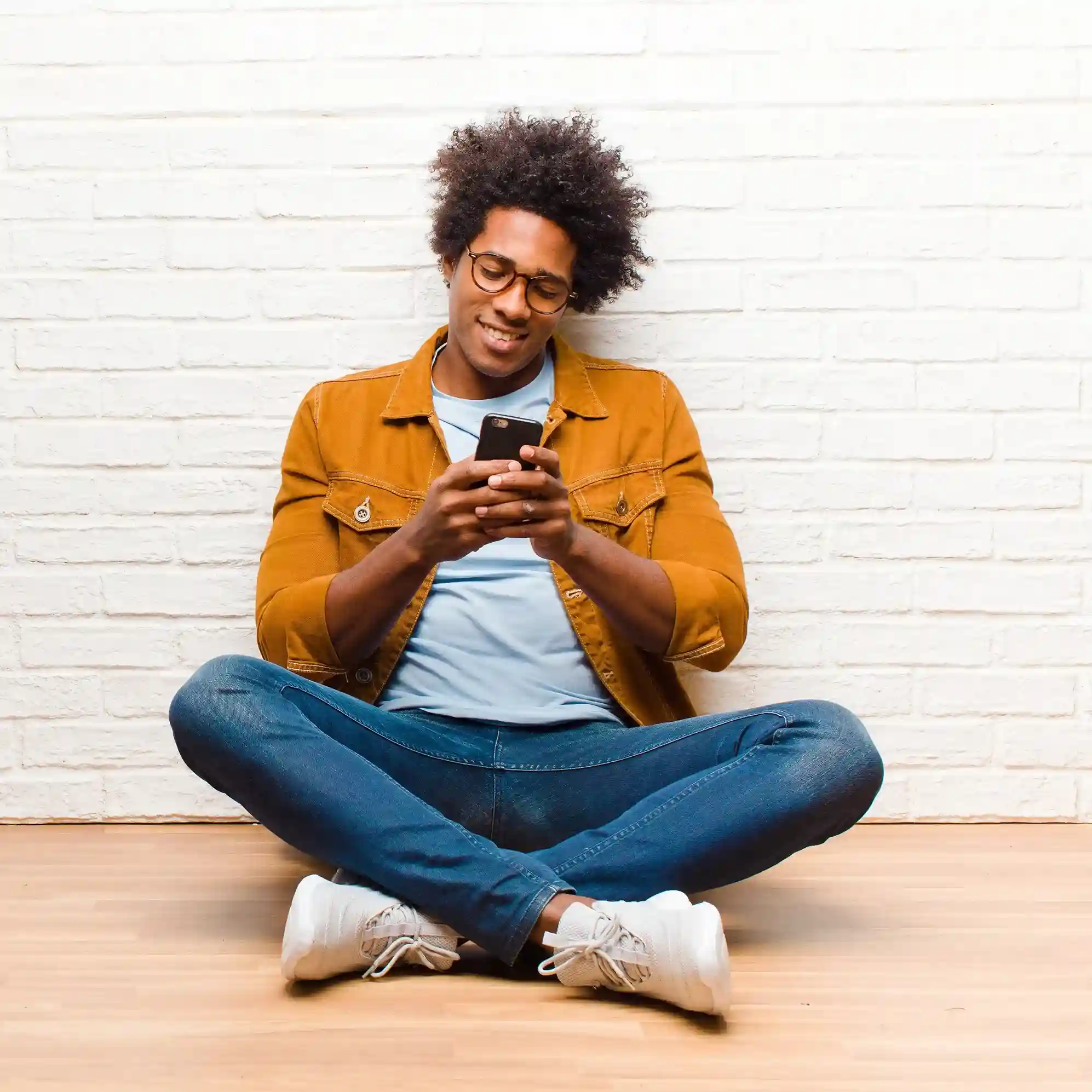 A relaxed professional reviews information on their phone, representing a decision to connect with a team that enables real-time agent coaching and smoother customer conversations. A professional checks their phone with confidence, reflecting a moment where teams explore how real-time call whispering can help supervisors guide agents during live customer conversations.