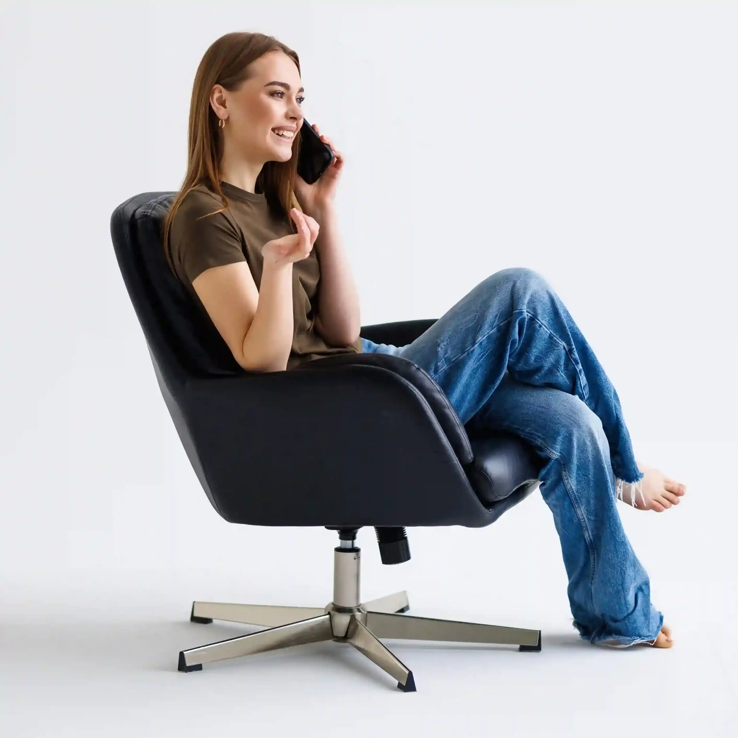 A team member relaxes during a controlled call moment, showing how focused work time is protected while customer calls are managed seamlessly in the background. A professional comfortably takes a phone call from her chair, confidently managing her availability while knowing incoming calls are handled without disrupting the customer experience.