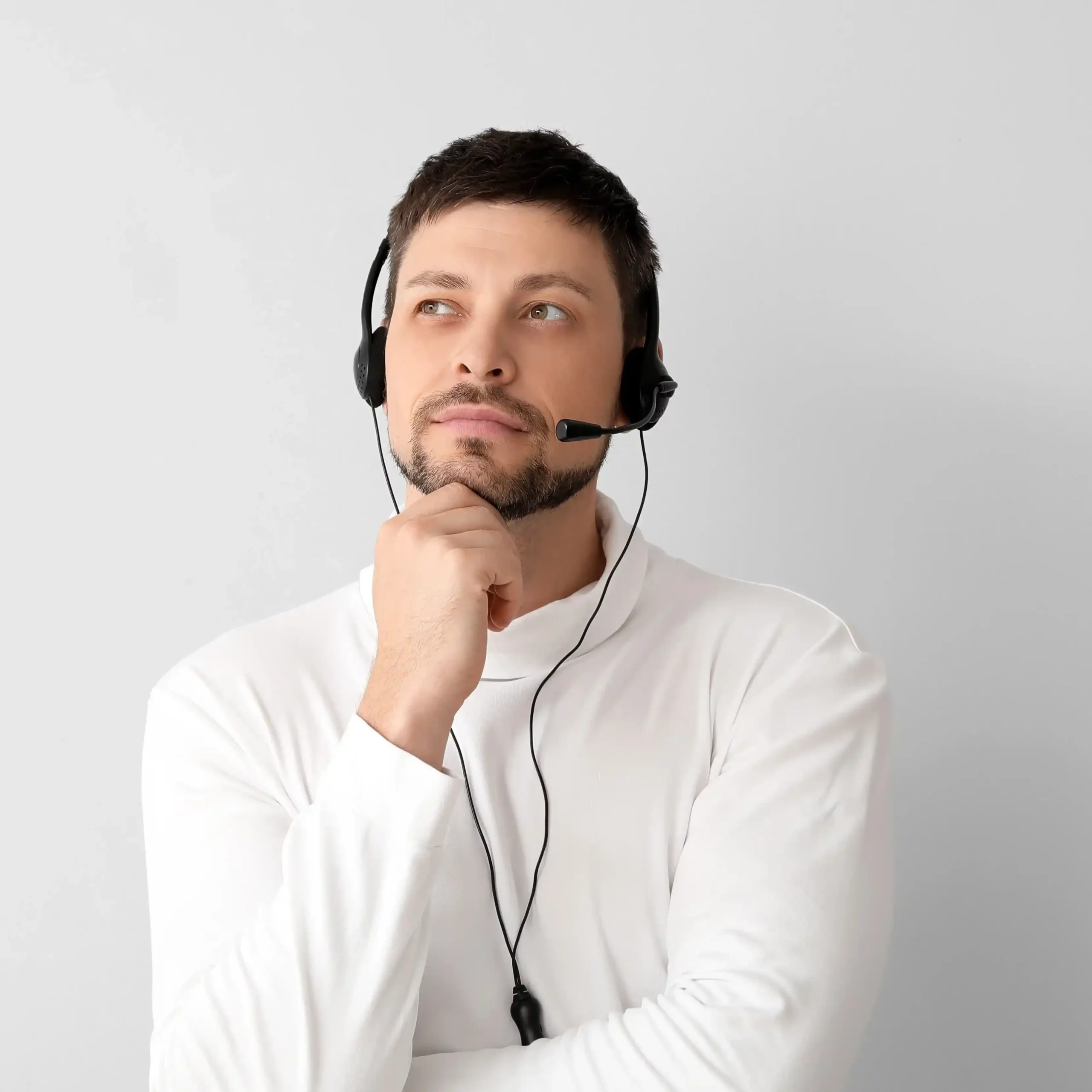 An agent listens carefully through a headset, relying on layered IVR menus to ensure callers are guided correctly before reaching live support. A contact center professional pauses thoughtfully during a call, using multi-level IVR logic to determine the most accurate path before routing the caller.