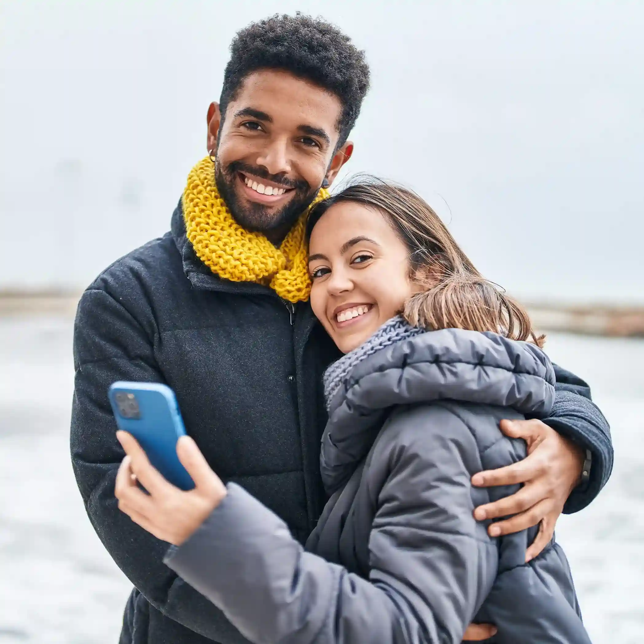 Returning customers review a call update together while agents identify their pinned contact and handle the interaction without delay. A couple smiles while checking a phone as agents instantly recognize their pinned contact and respond with confidence from the first moment of the call.