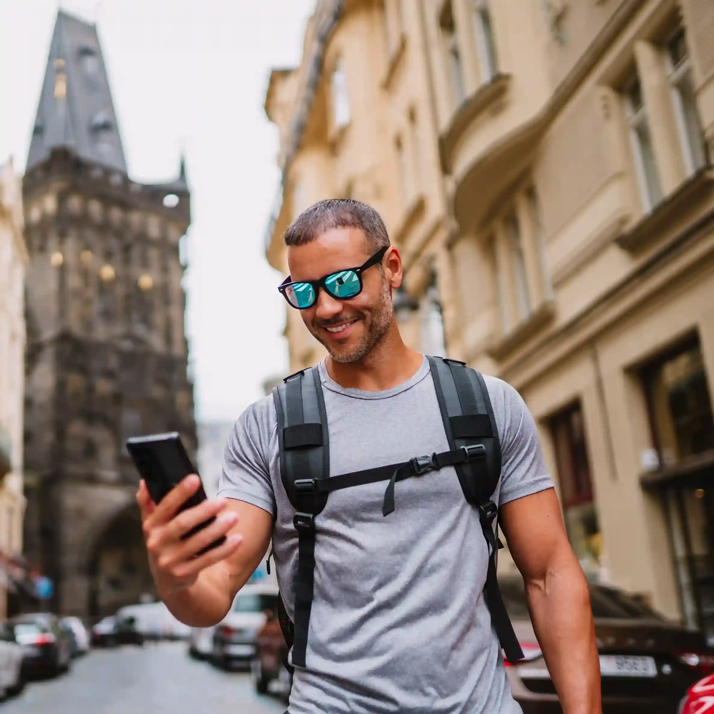 As he moves through a busy urban setting, a traveler reviews an SMS message designed to keep him informed, reflecting structured SMS campaigns powered by filtering rules. Walking through a city street, a traveler checks an SMS update that arrives at the right moment, showing how proactive filtering keeps communication timely and useful.