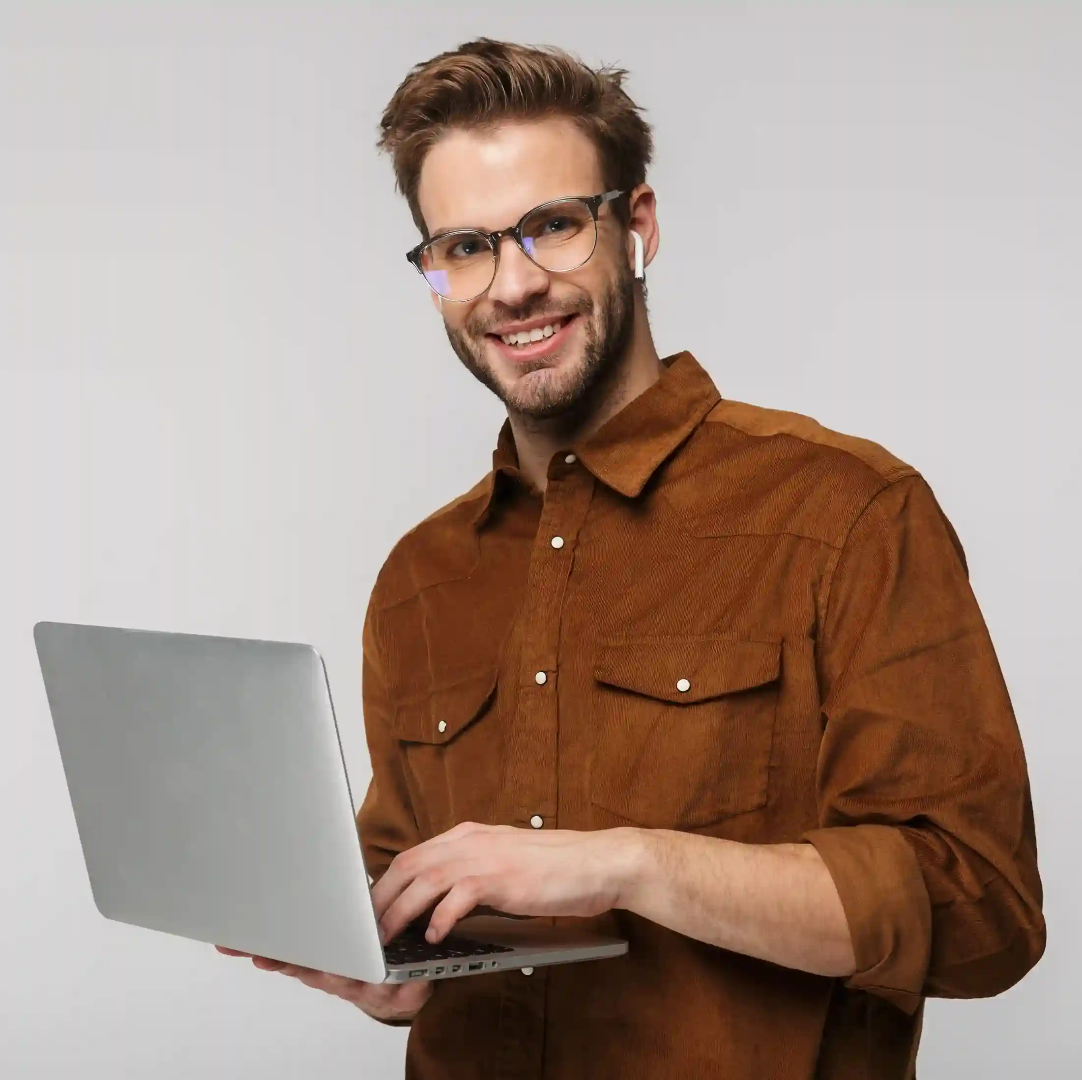 A business professional works confidently on his laptop, setting up toll-free numbers to make customer communication more accessible and easier to start. A professional smiles while working on a laptop, preparing to enable toll-free calling so customers can reach the business easily without worrying about call costs.