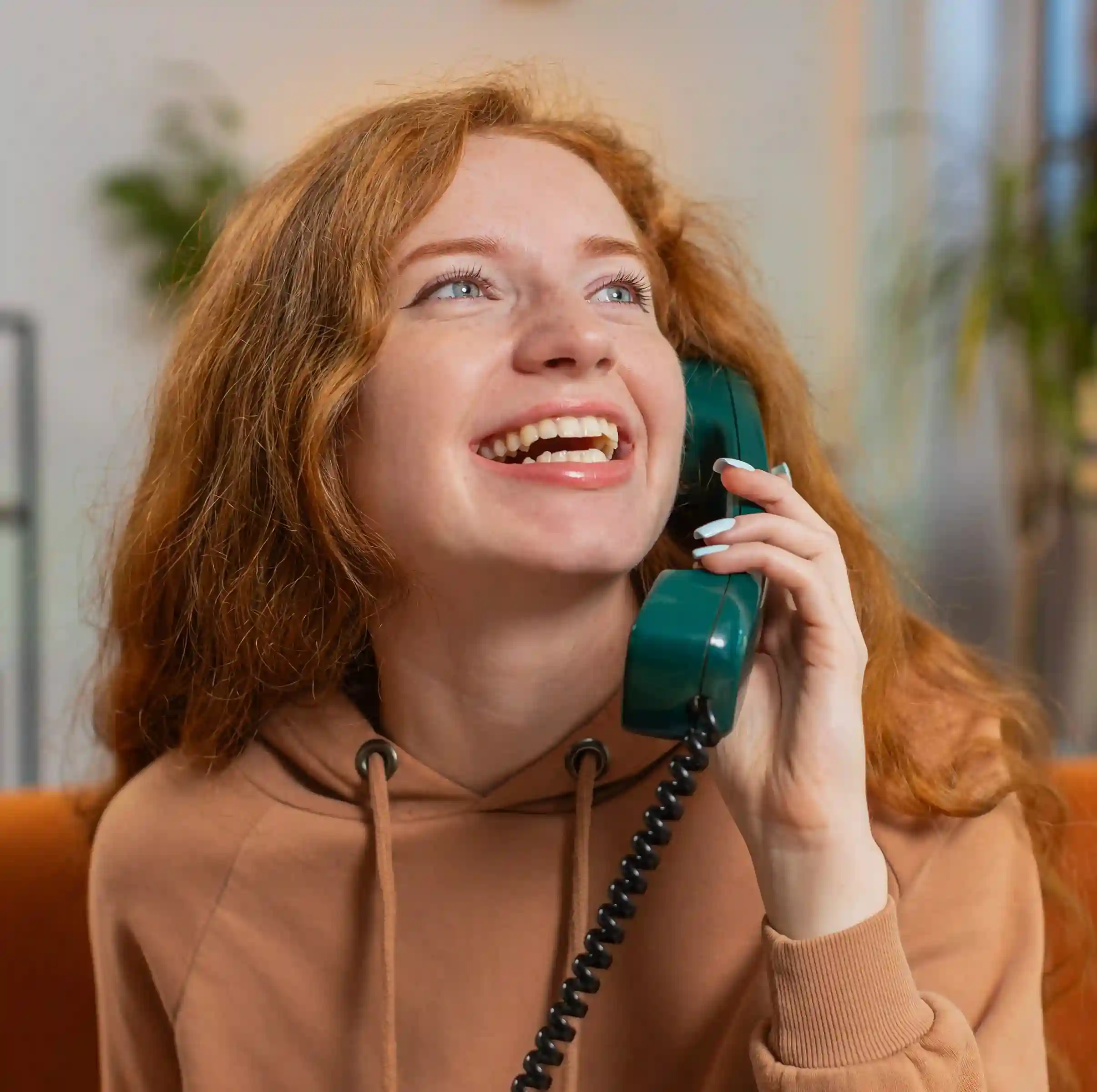 A support agent stays engaged during a phone conversation, relying on a unified call interface that keeps the interaction smooth and easy to manage. A customer service professional smiles while speaking on a call, confidently managing the conversation through a single unified workspace without added complexity.