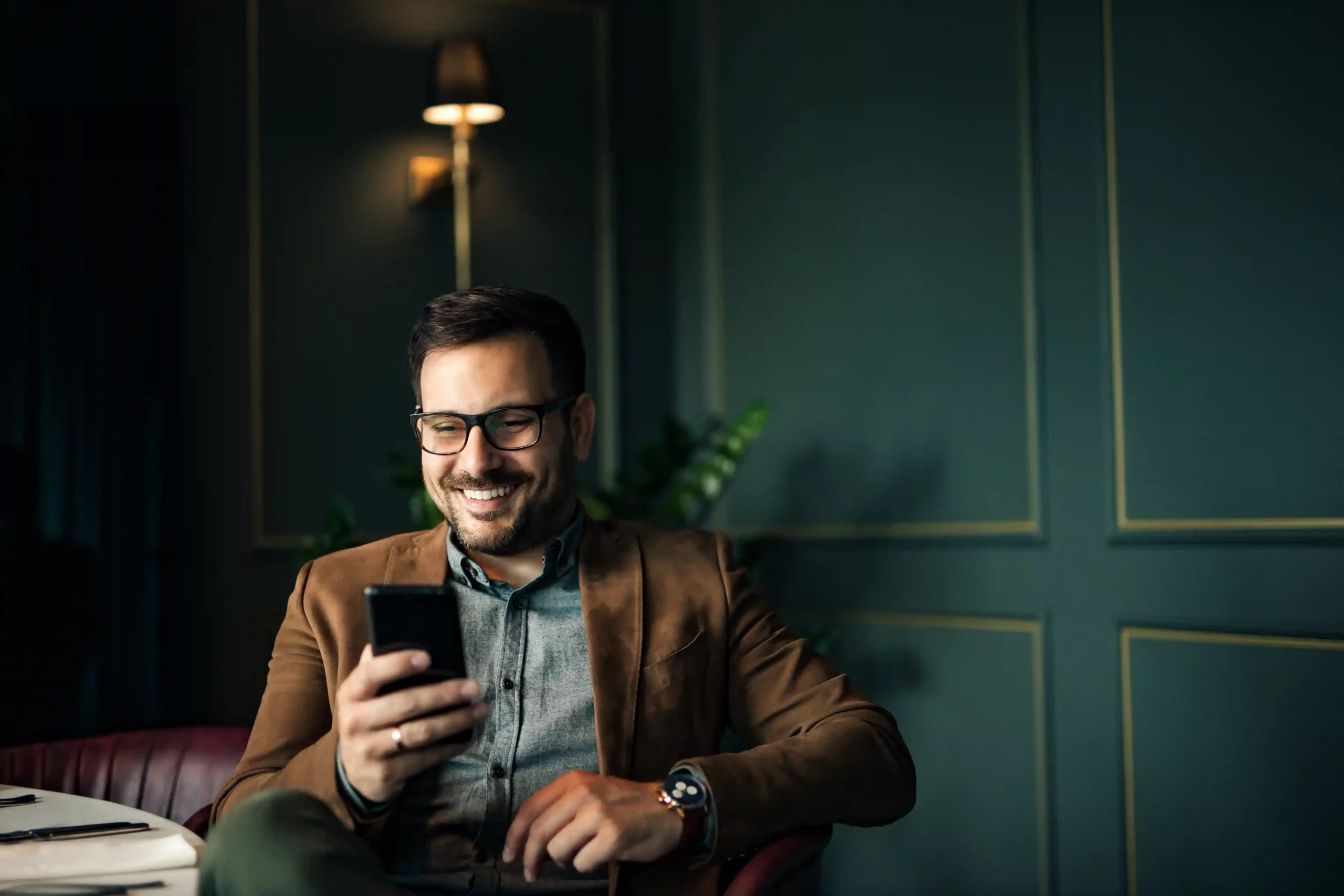 A manager smiles as an incoming call reaches him instantly, reflecting how call extensions provide direct access to the correct user without added routing layers. A business professional relaxes while checking his phone, receiving a call routed directly to him through call extensions without needing to go through multiple steps.
