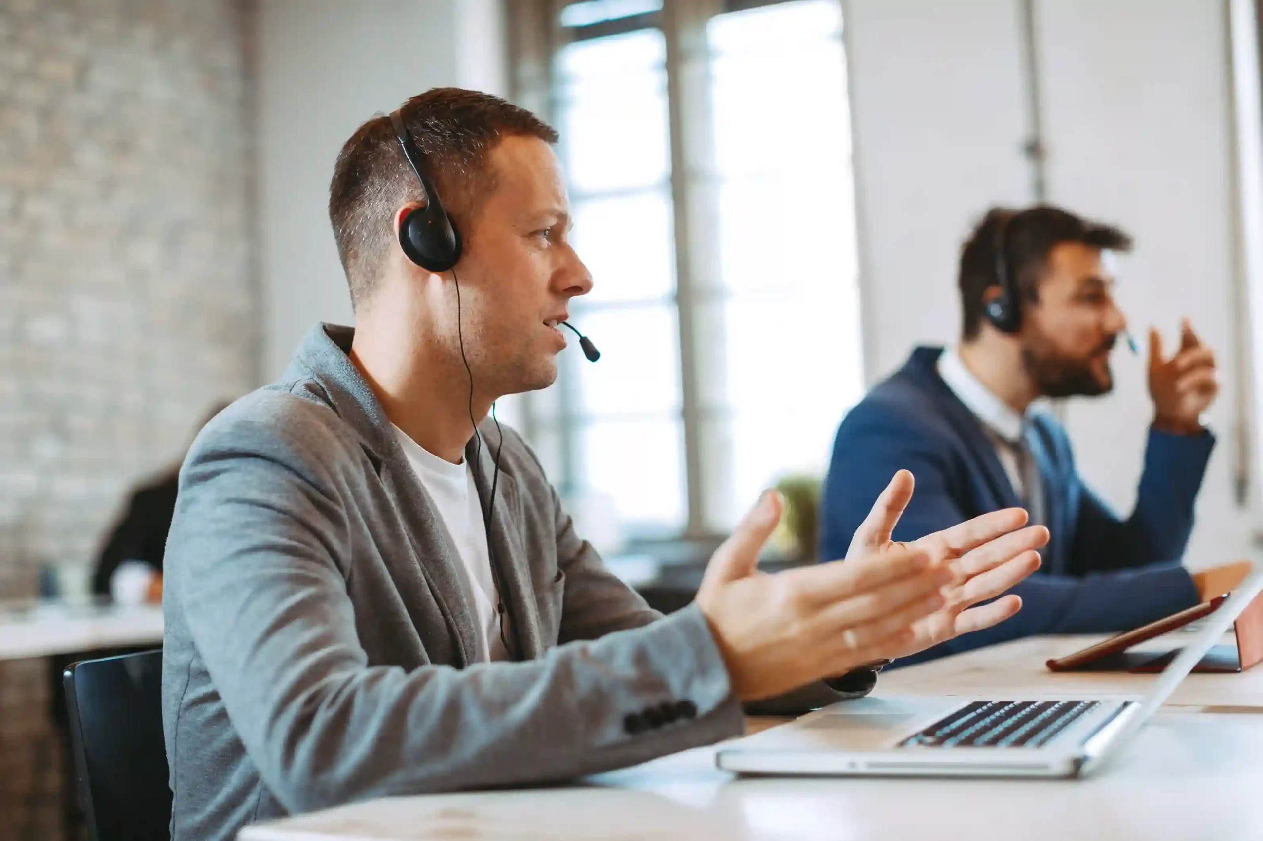 A focused agent preparing to dial, using a clean interface to select the correct outbound number before connecting. A contact center agent mid-conversation, quickly selecting the right caller ID on his screen before placing the next call.