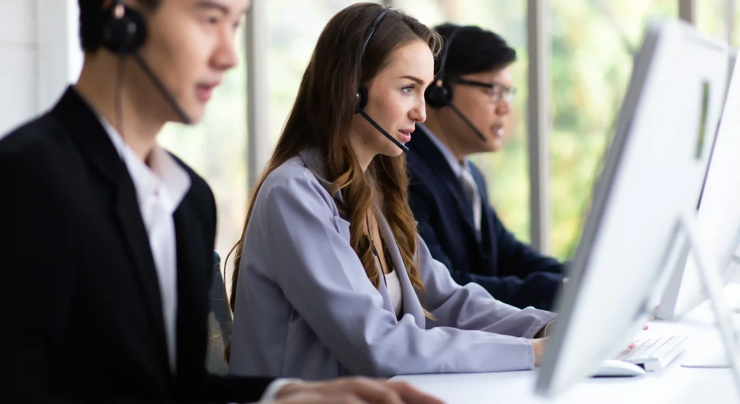 An agent works efficiently alongside teammates, using a single interface to review caller information and take action without slowing the call. Call center agents focus on active conversations at their screens, quickly accessing call details and actions from one unified workspace without pausing the discussion.
