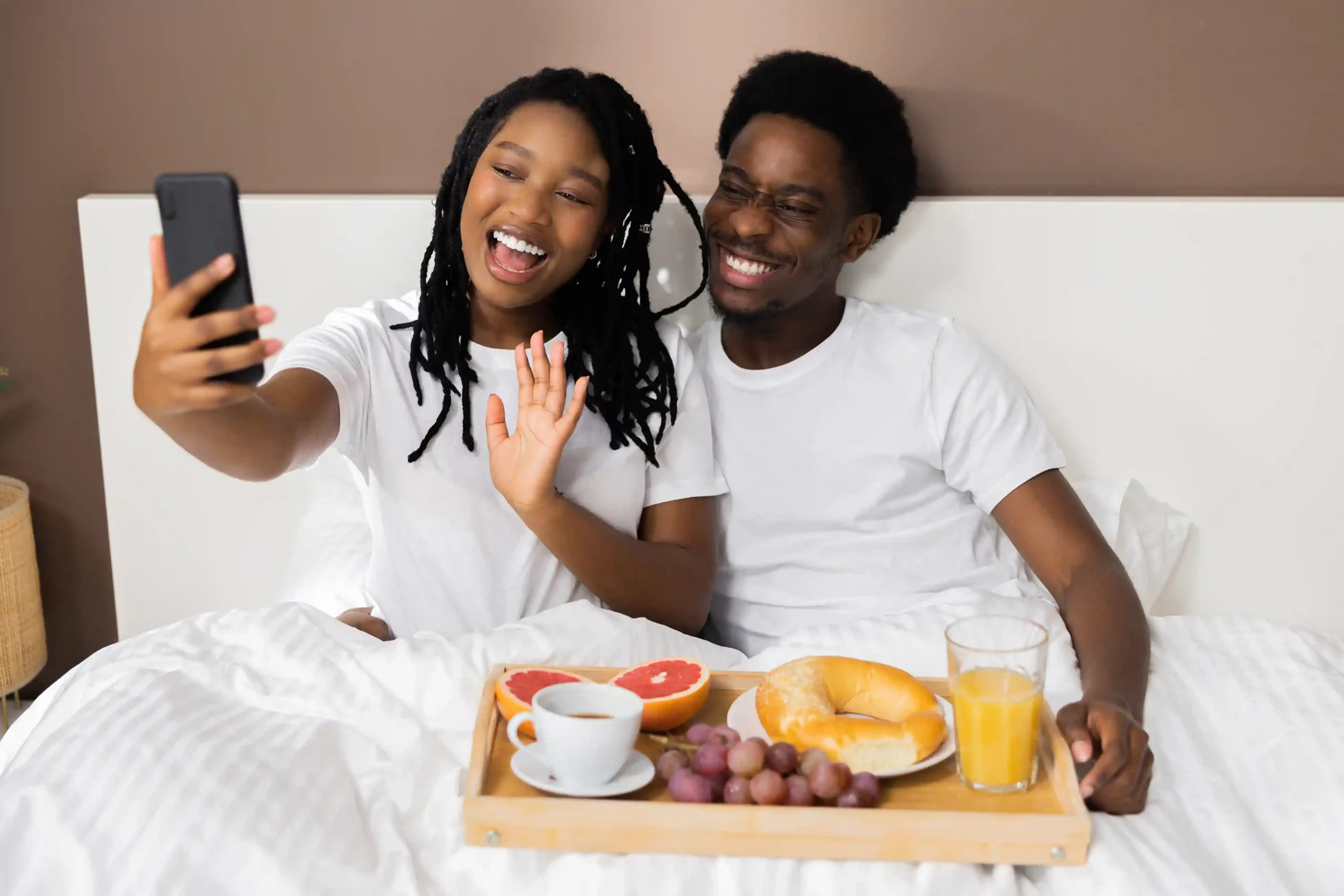 Hotel guests relax over breakfast as their earlier voicemail request is handled promptly, showing how Indosoft filters ensure urgent messages reach teams without delay. A couple enjoys breakfast delivered on time in a hotel room, reflecting how Indosoft voicemail filters help staff prioritize time-sensitive requests and respond quickly.