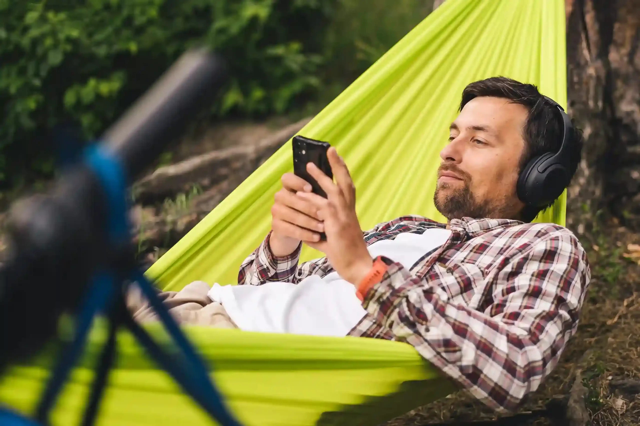 An agent relaxes in a hammock while reviewing information on his phone, illustrating how reduced call interruptions allow focused work time without unexpected disruptions. An agent relaxes in a hammock while reviewing information on his phone, illustrating how reduced call interruptions allow focused work time without unexpected disruptions.