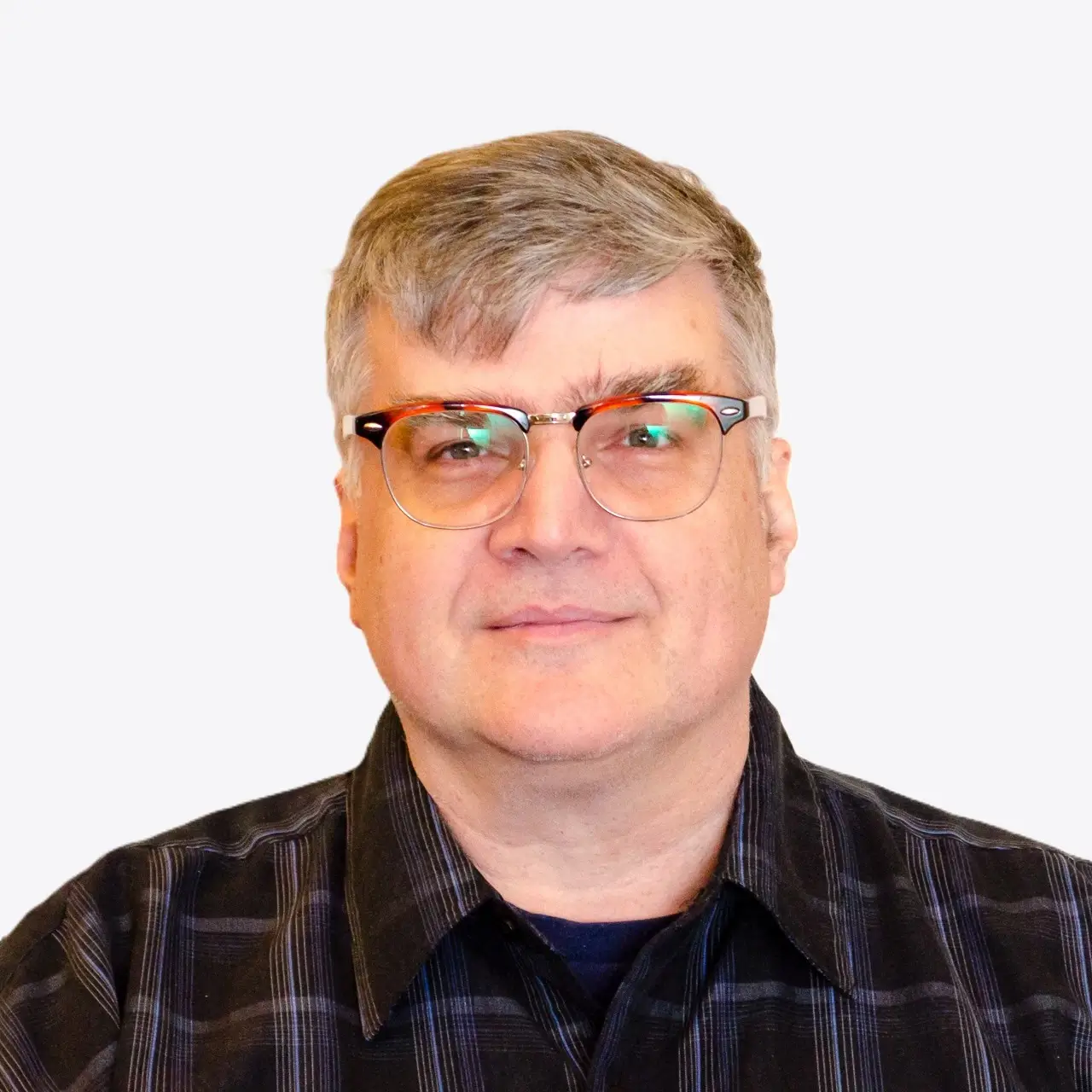 This professional headshot highlights Stephen Ray, who has been part of Indosoft since 2005. Starting in customer support and growing into a key product leader, Stephen has consistently helped clients succeed by guiding effective use of Indosoft’s software and influencing feature development based on real-world call center challenges. Portrait of Stephen Ray, Indosoft product leader known for hands-on client collaboration and CTI innovation