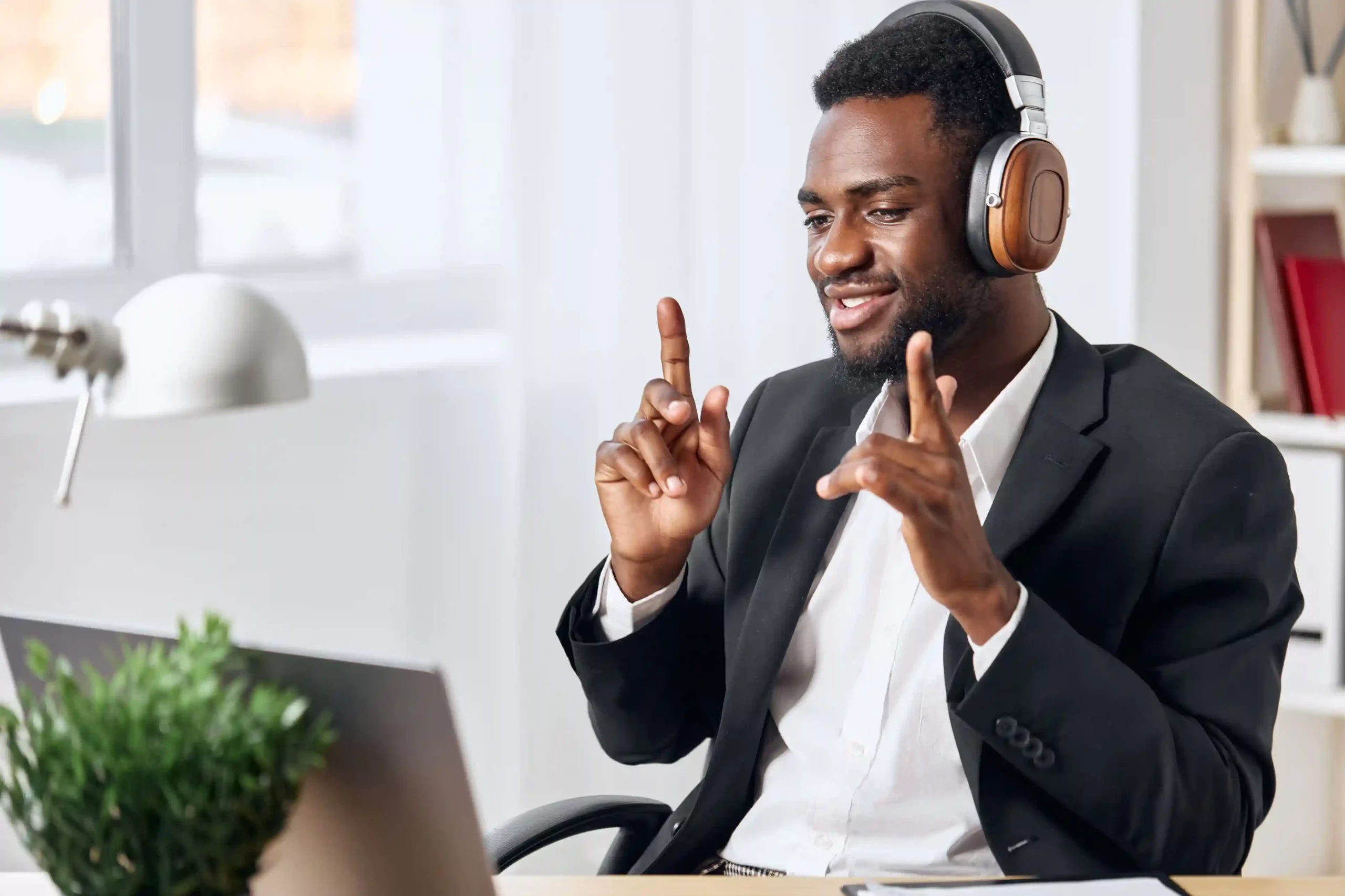 A focused agent coordinates with others during a live conference call, aligning responses in real time to address a customer concern efficiently. An agent wearing a headset gestures confidently while speaking through a live call, bringing another expert into the conversation to resolve a customer issue without delay.