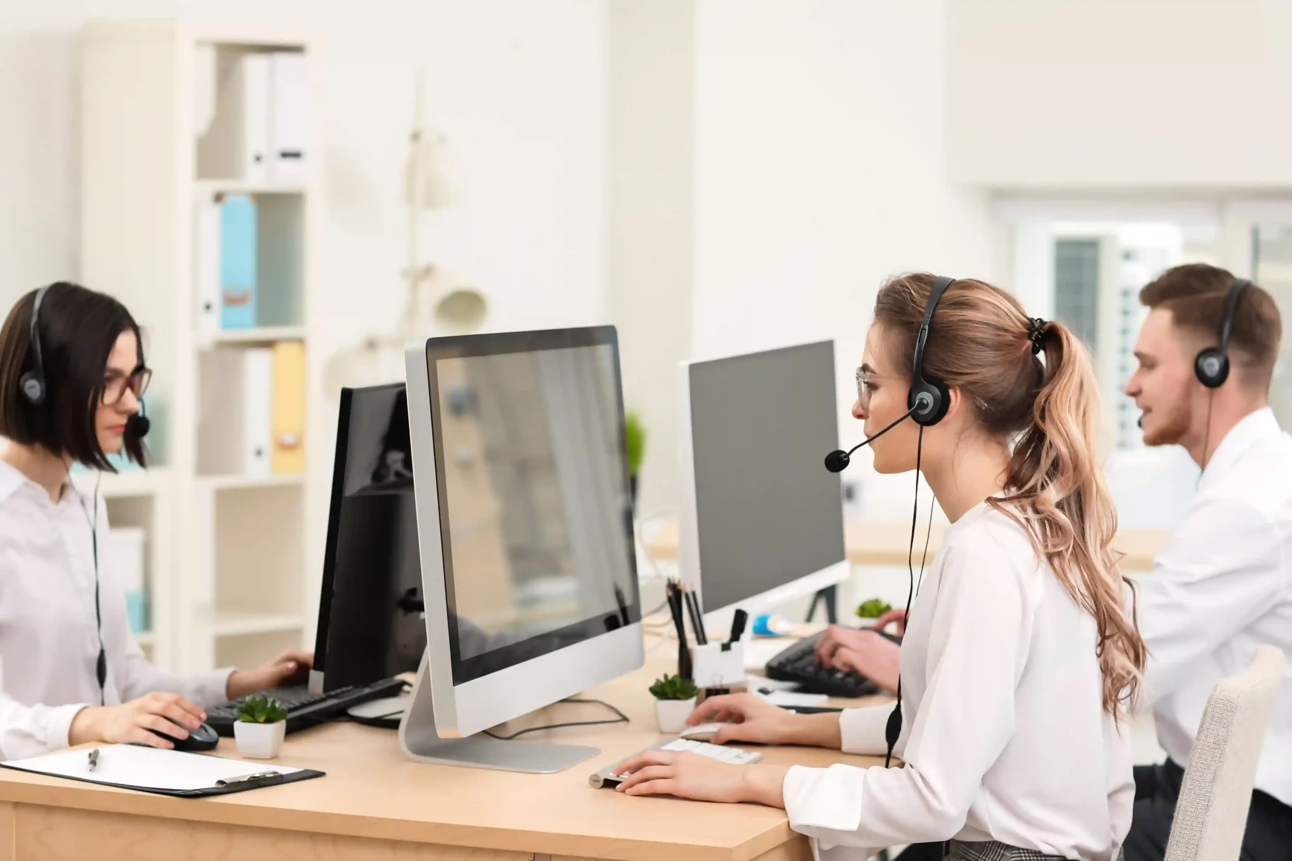 Agents focus on assisting customers as IVR handles initial call routing, allowing callers to select the right option before reaching the support team. A call center team works efficiently at their desks while IVR guides callers through clear menu options, ensuring each call reaches the correct agent without confusion.