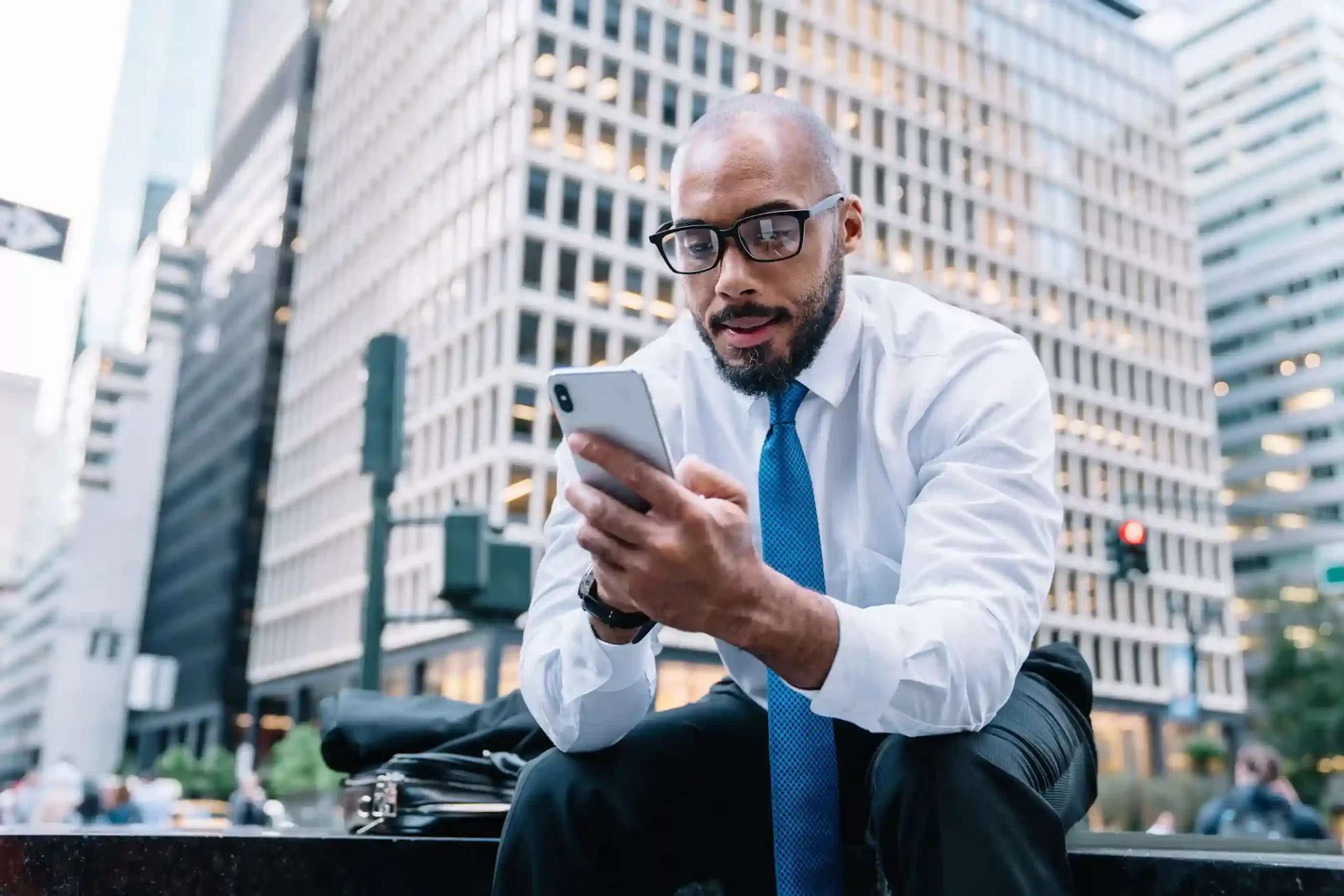 An executive confidently handles an incoming call routed correctly the first time, guided by IVR input rules that eliminate extra transfers. A business executive reviews a call on his phone in the city, connected directly through IVR routing that uses caller input to avoid unnecessary transfers.