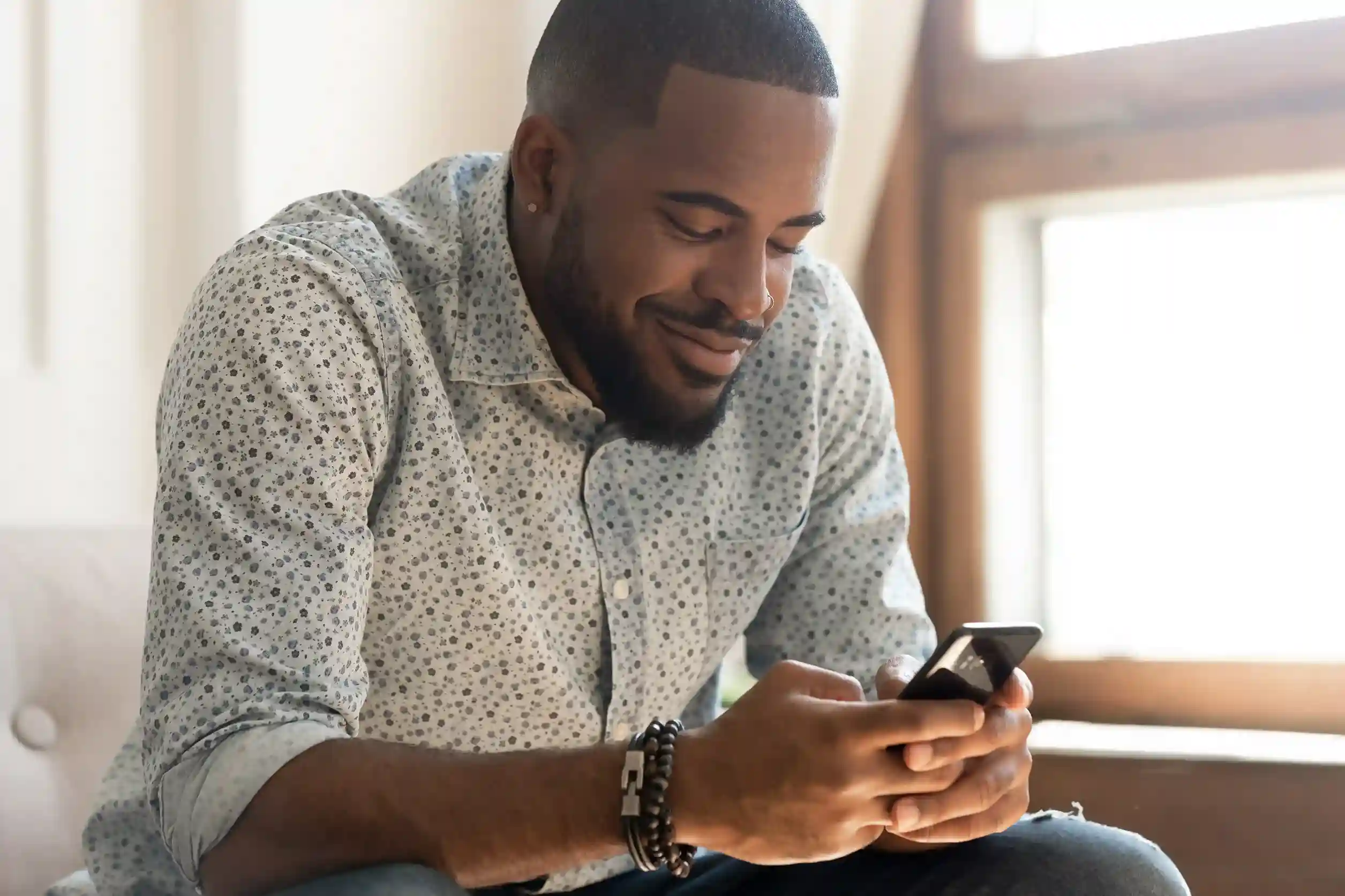 Indosoft Number Porting supports local, toll-free, and business numbers so teams can consolidate communications across departments and locations. A professional reviews messages on his phone, confidently managing local and toll-free business numbers after porting them all to Indosoft for seamless communication.