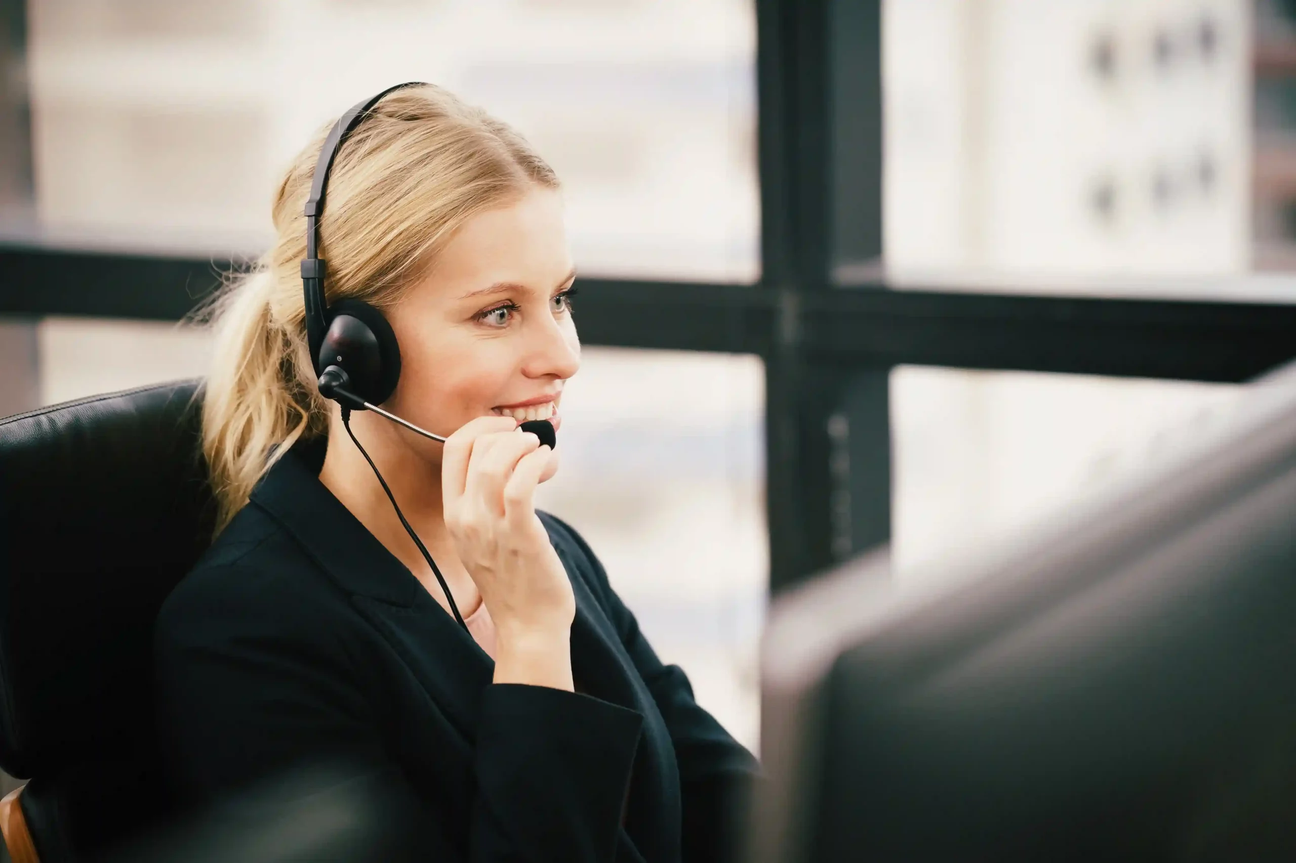 A support agent listens attentively on a headset, responding to a toll-free call that connects customers from anywhere without regional barriers. A call center executive answers an inbound call through a toll-free number, supporting customers from different regions through a single point of contact.