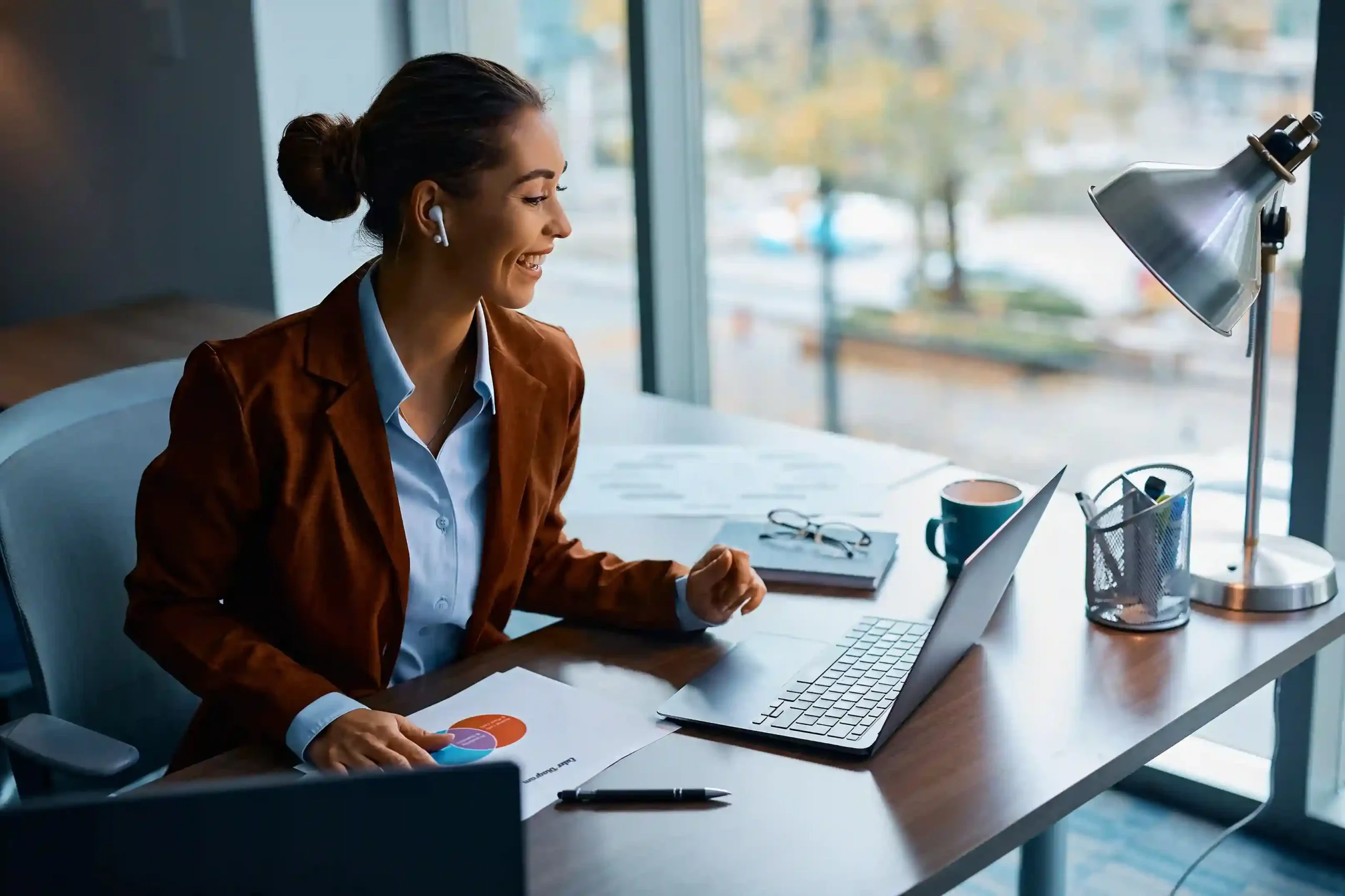 A professional agent focuses on her screen and initiates a customer call directly from the system, showing how one tap dialing simplifies everyday outbound outreach. An agent reviews customer details on her laptop and starts an outbound call with a single click, avoiding manual dialing and keeping the conversation moving smoothly.