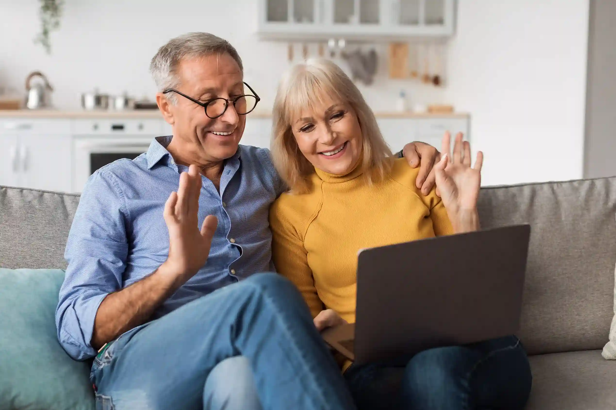 A senior couple reacts positively to a scheduled call notification on their laptop, illustrating how Indosoft automatically routes and prioritizes calls through organized queues. An elderly couple smiles while joining a call after receiving a timely dentist appointment update, reflecting how Indosoft places incoming calls into structured queues based on priority.