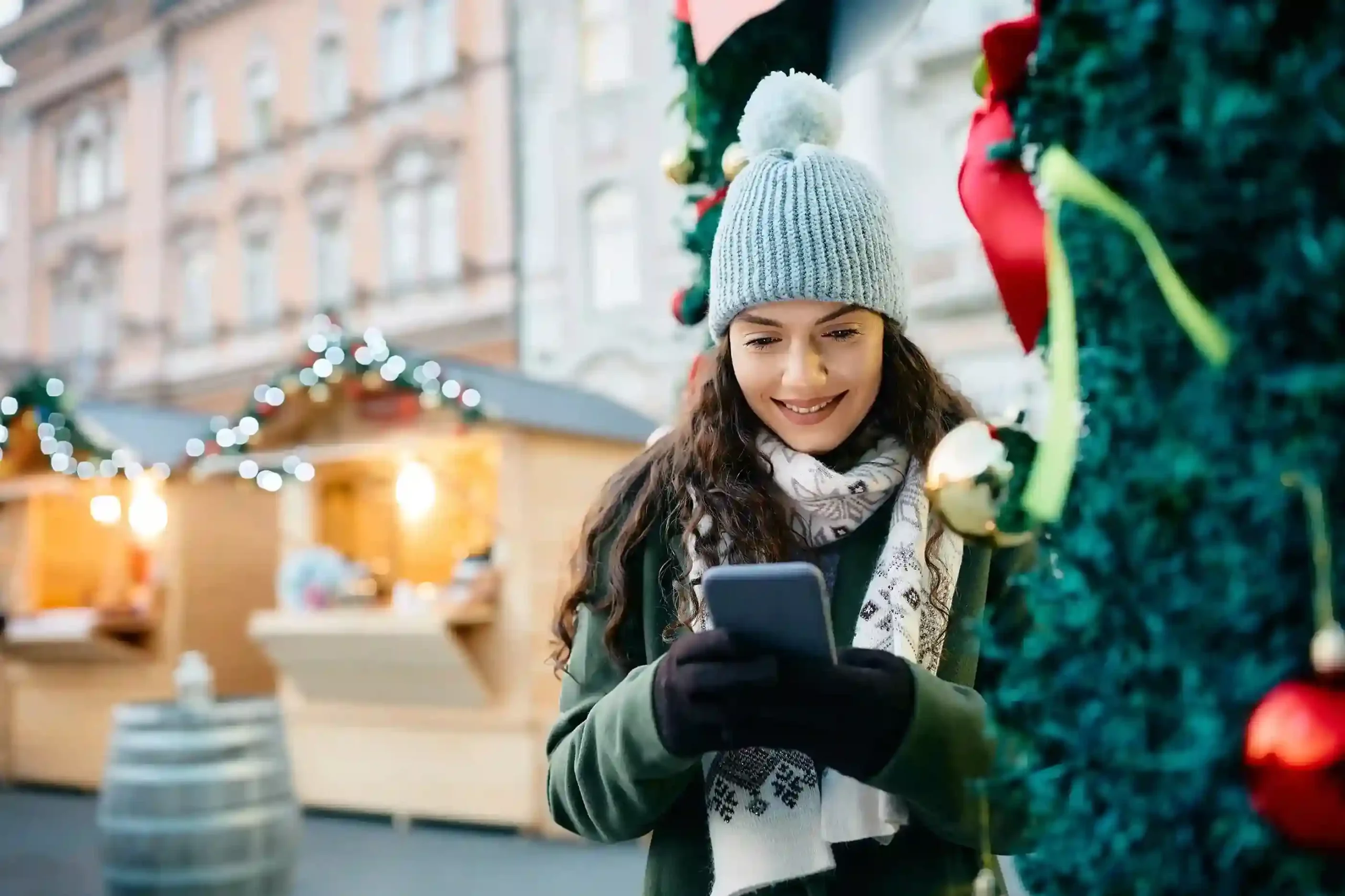 A customer pauses holiday shopping to answer a call that stands out as a pinned contact, signaling its importance before the conversation begins. A frequent shopper checks her phone during the holiday season after receiving a priority call that is instantly recognized through a pinned contact.