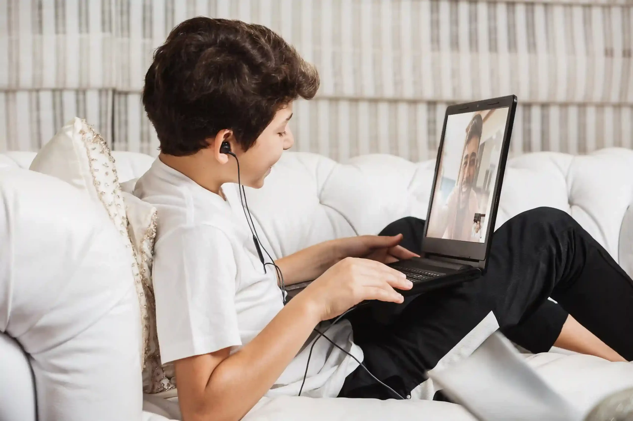 During a video call at home, a child’s contact information stays protected, reflecting how Indosoft supports private contact visibility without exposing sensitive records to others. Relaxing at home, a child connects with a parent through a laptop while their contact details remain private, showing how Indosoft keeps sensitive contact information visible only to selected users.