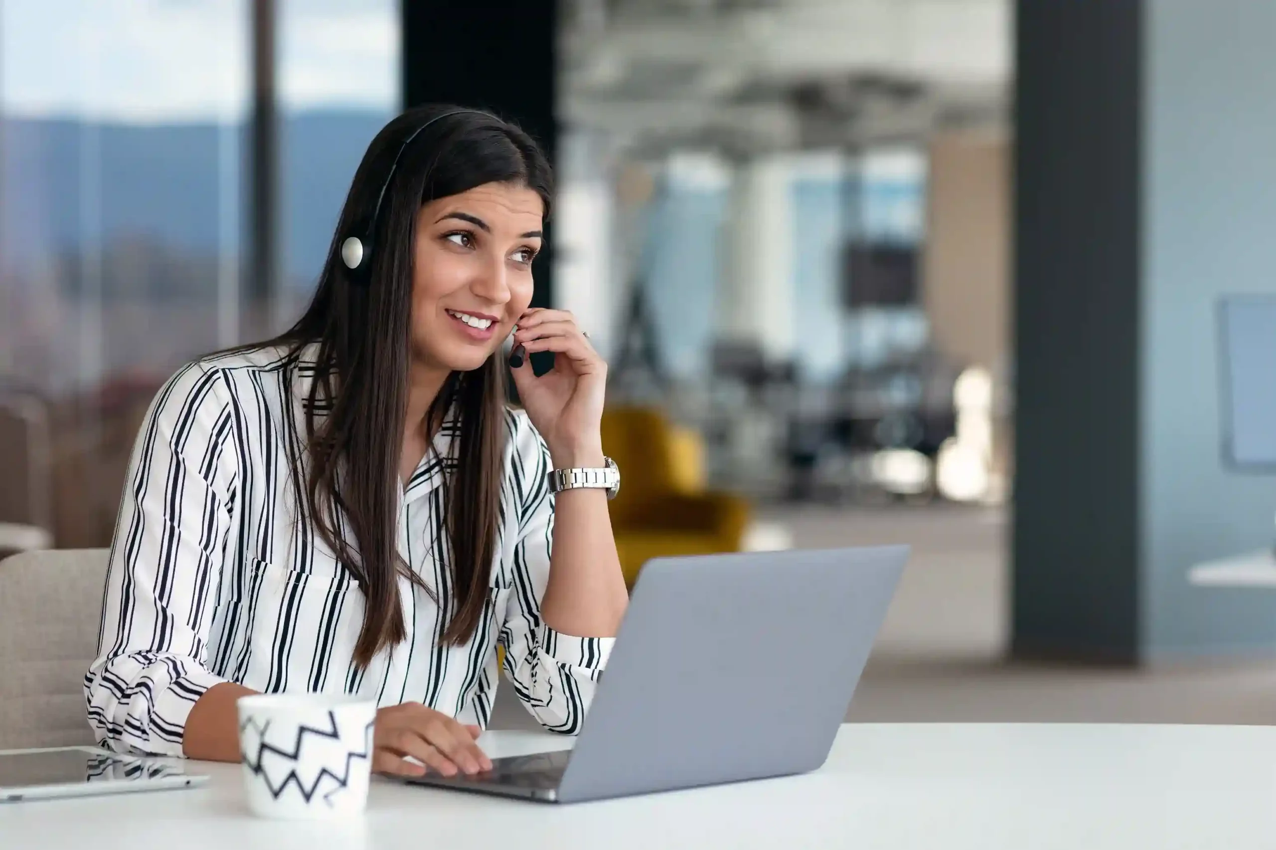 An agent listens attentively while using Indosoft’s call monitoring tools to follow a customer conversation in real time. A support agent reviews a live customer conversation on her laptop, using Indosoft call monitoring to understand the interaction as it unfolds.