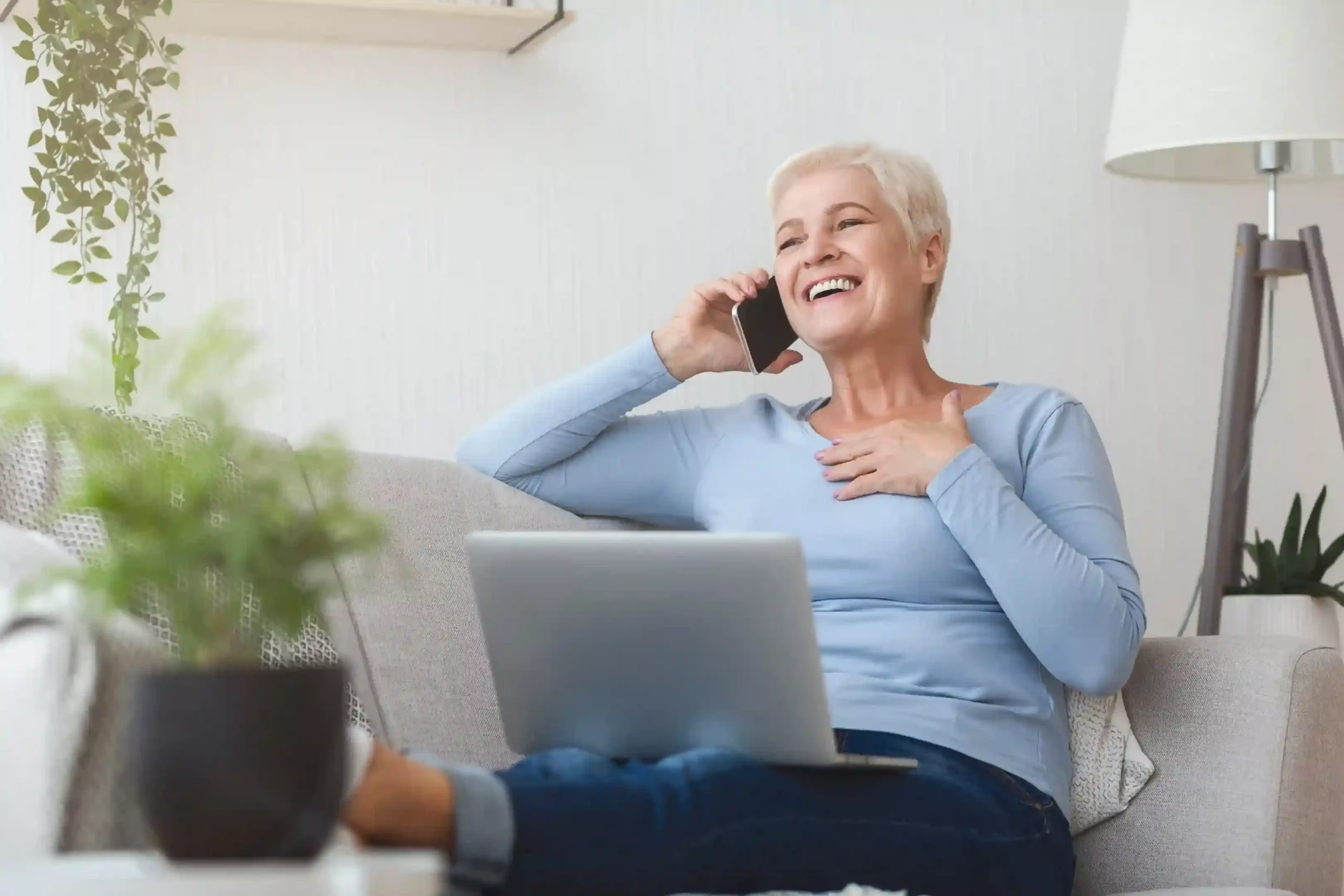 A senior citizen speaks comfortably on the phone during a scheduled call, reflecting Indosoft’s masked communication safeguards. A senior relaxes at home while receiving a scheduled follow-up call, showing how Indosoft call masking prevents personal number exposure.