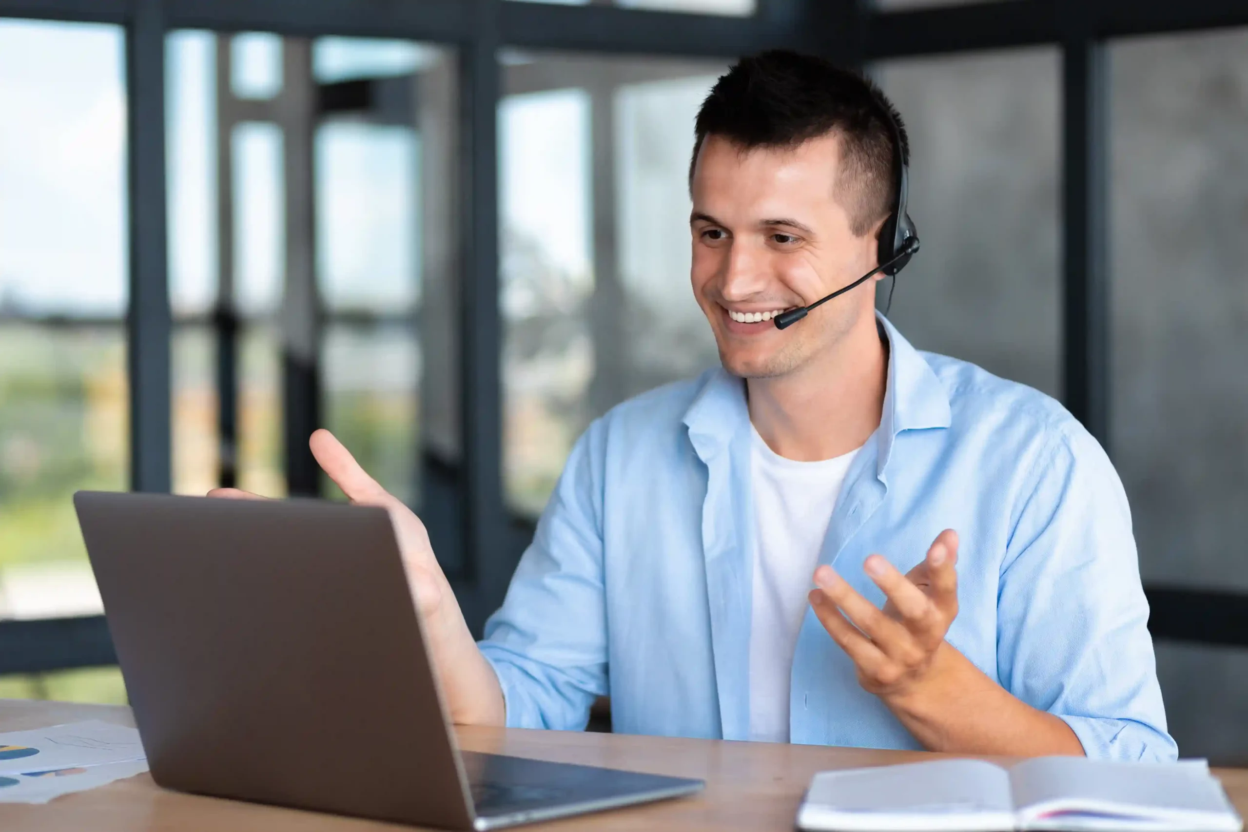 A contact center agent gestures while on a headset, managing the conversation smoothly using a single interface instead of navigating between systems. An agent confidently speaks with a customer while viewing all call details on one screen, staying focused without switching between multiple tools.