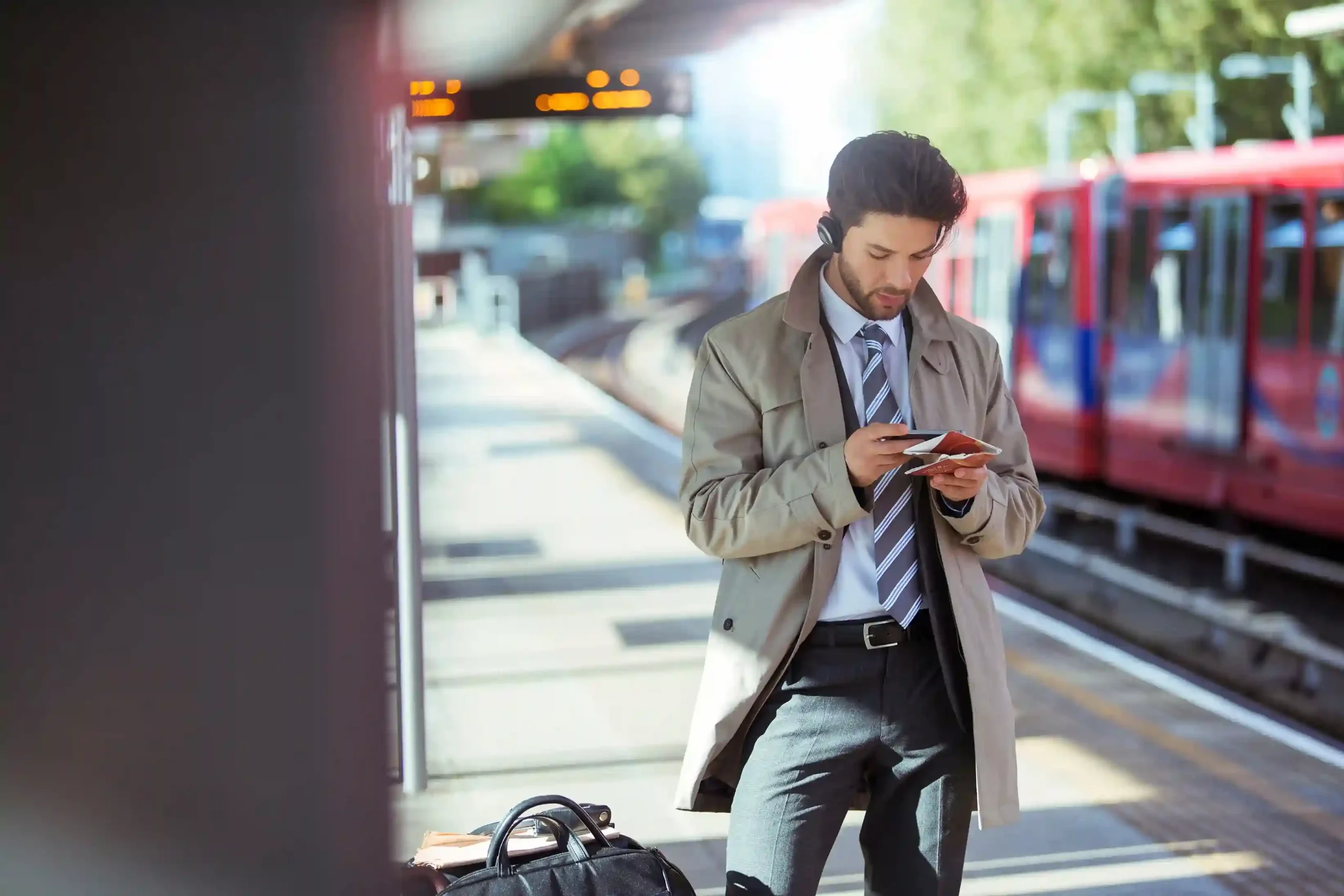 Number Porting allows businesses to move existing phone numbers to Indosoft without disrupting customer communication. A professional checks a train arrival message on his phone while heading to the platform, continuing to receive updates on the same trusted number after porting it to Indosoft.