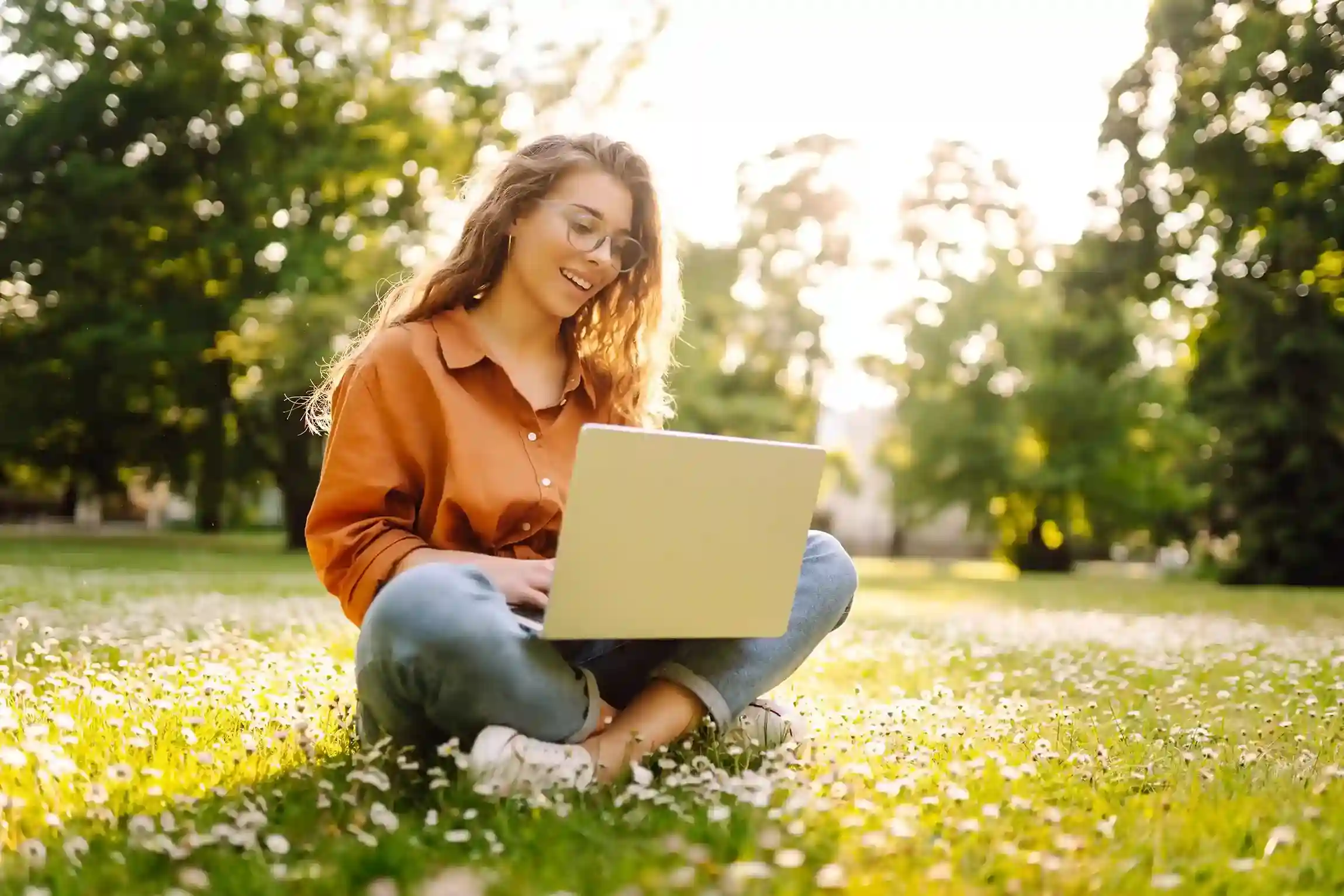 Working from an outdoor setting, an employee builds SMS segments on her laptop, carefully selecting customer groups before sending targeted messages. An employee sits outdoors with a laptop, thoughtfully organizing customer contacts into SMS segments so messages reach only the most relevant audience.