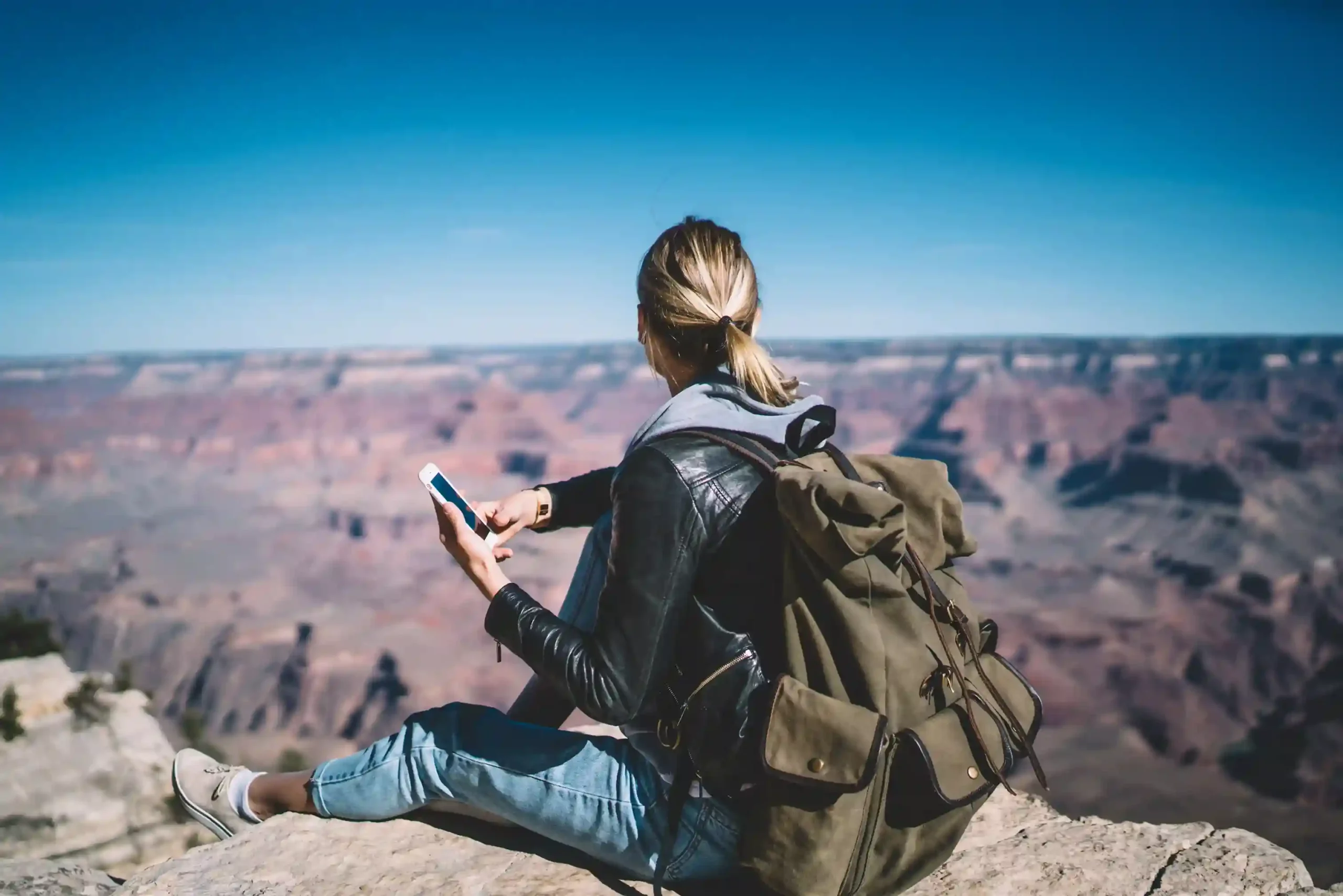 While overlooking a scenic destination, a traveler receives a timely scheduled message that helps her stay on track, reflecting how planned messaging supports consistent outreach Pausing during a solo trip, a traveler checks a scheduled reminder on her phone, showing how preplanned messages arrive on time even when businesses are offline
