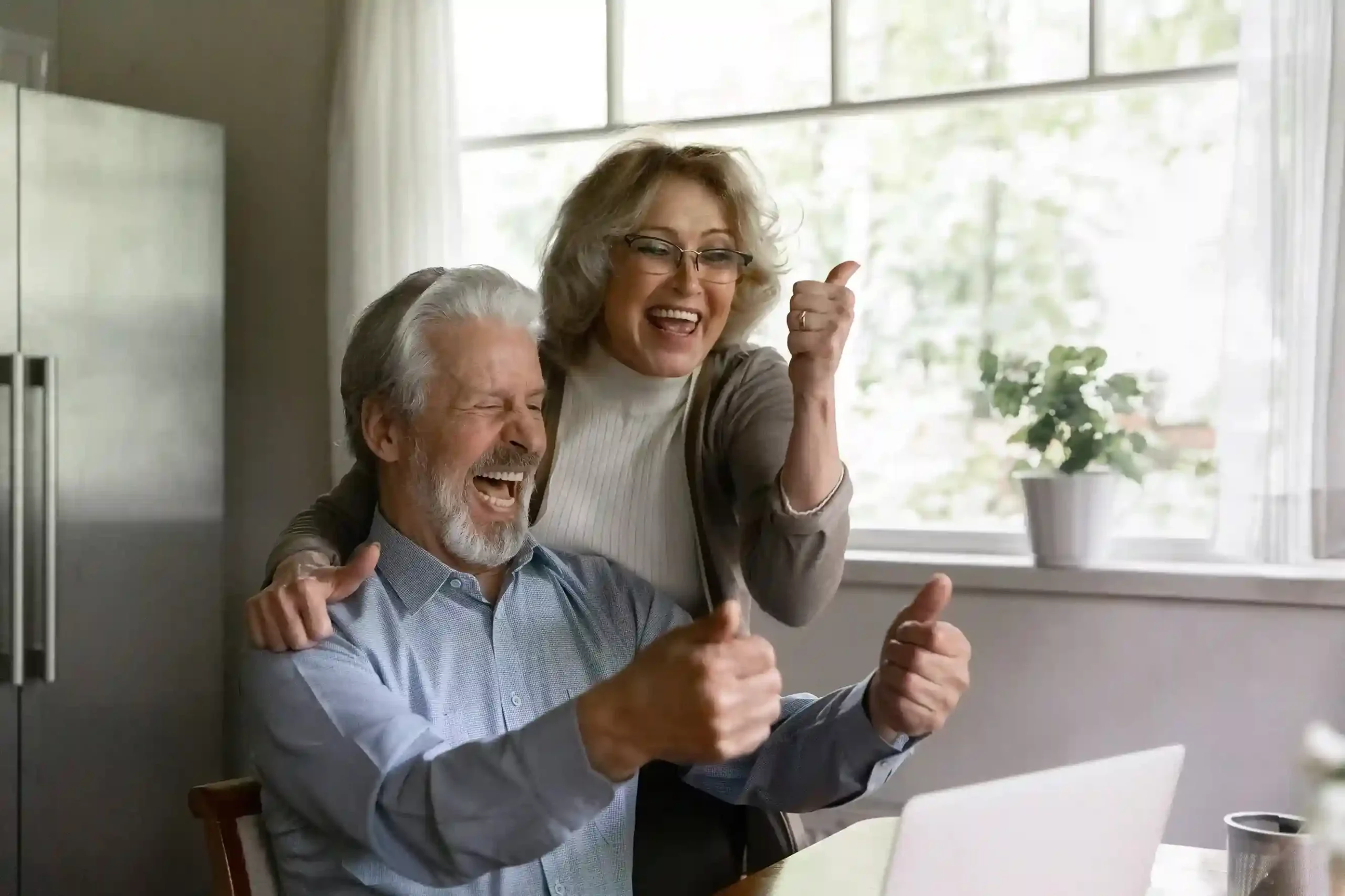 A customer enjoys a calm and reassuring call as the agent confidently responds, supported by behind-the-scenes coaching that improves accuracy in real time. A senior couple smiles with relief as their question is answered clearly, while the agent receives quiet guidance that helps keep the conversation smooth and accurate.