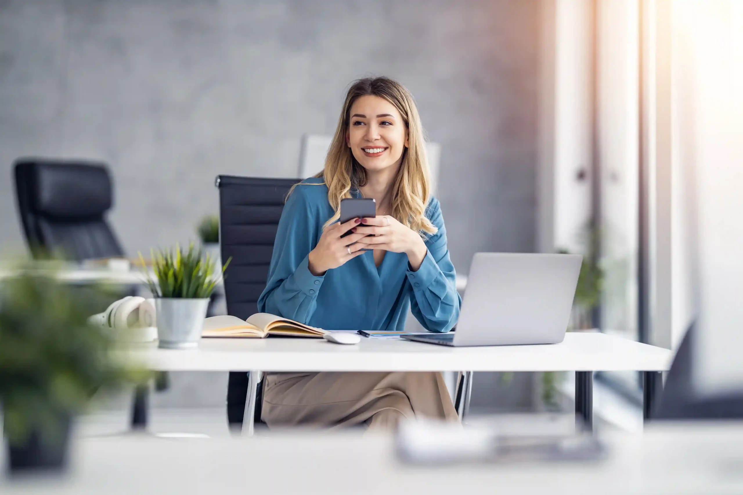 Indosoft Shortcodes simplify opt-in interactions, allowing customers to confirm subscriptions or reservations quickly without navigating complex steps. Seated at her desk, an employee checks a reservation confirmation text and opts in with a simple reply, completing the process in seconds using a recognizable shortcode.