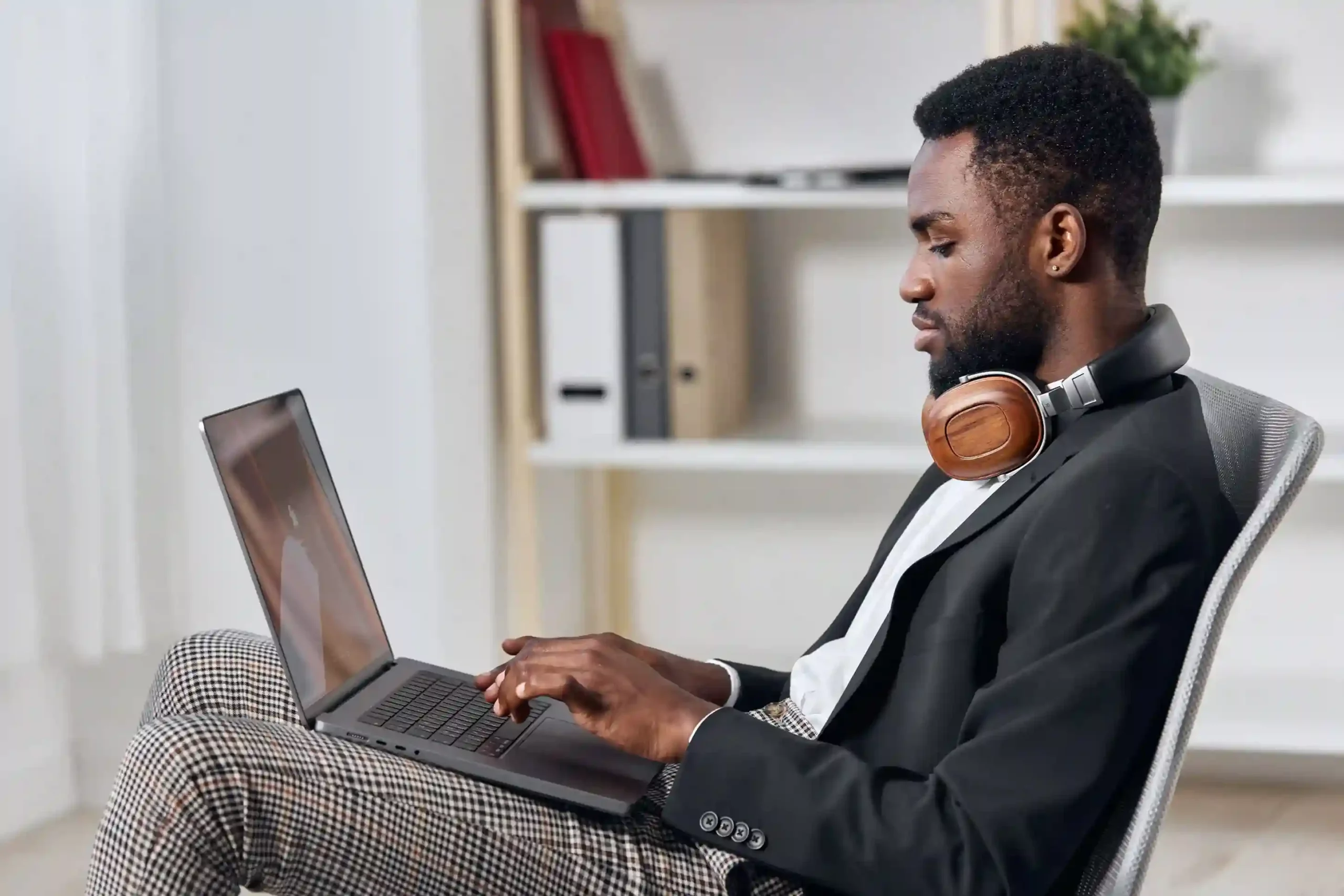 An agent focuses on their screen while configuring call settings, relying on local numbers to ensure nearby customers can reach the right support team without confusion or hesitation. A professional works calmly on a laptop with a headset nearby, using a local phone number setup to manage incoming calls efficiently and respond to customers without delays.