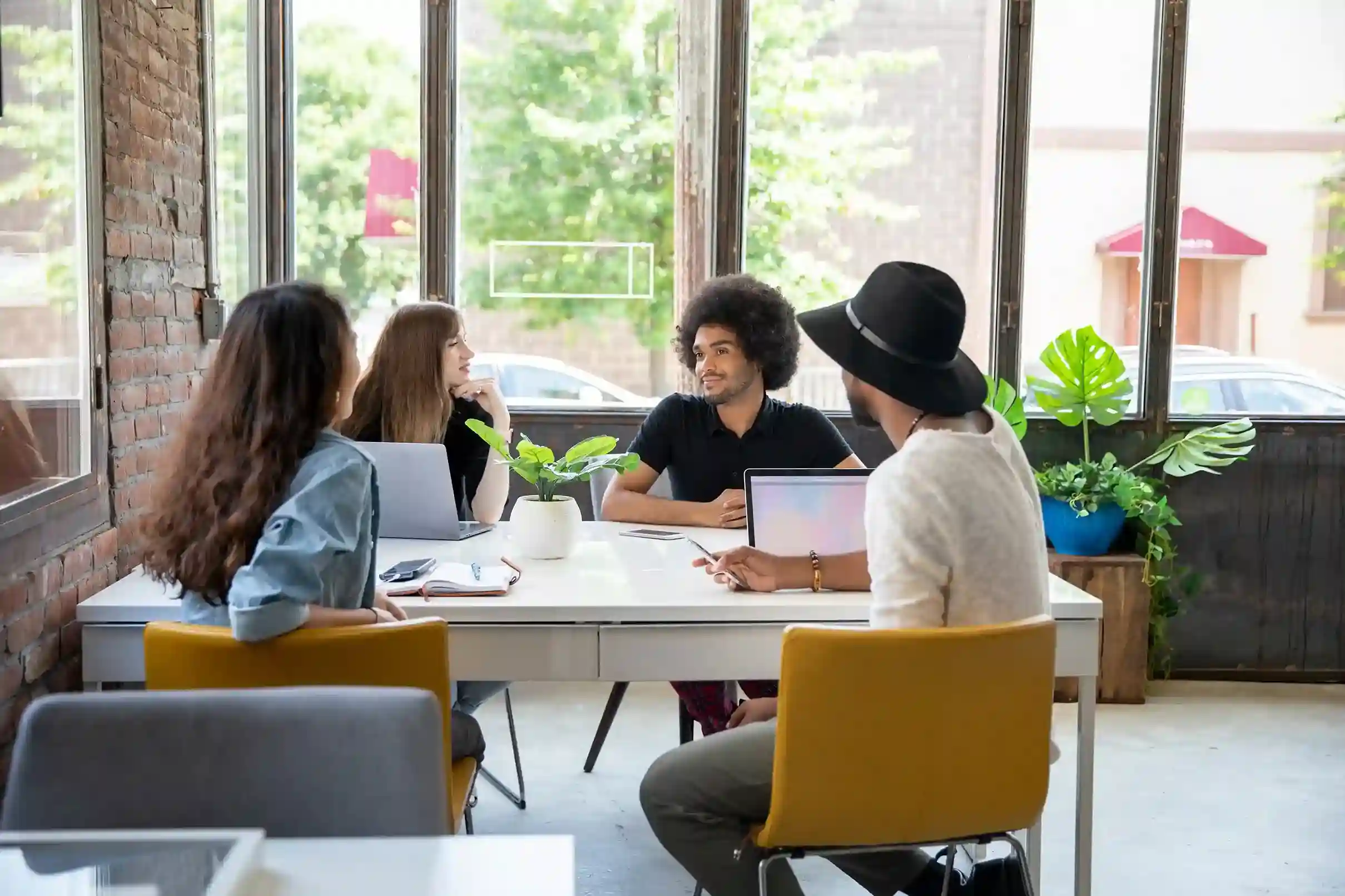 Team of entrepreneurs meeting to explore Indosoft’s scalable communication system that grows effortlessly with their startup. Startup team gathered around a table discussing how Indosoft’s scalable cloud platform can support their business growth and expansion.