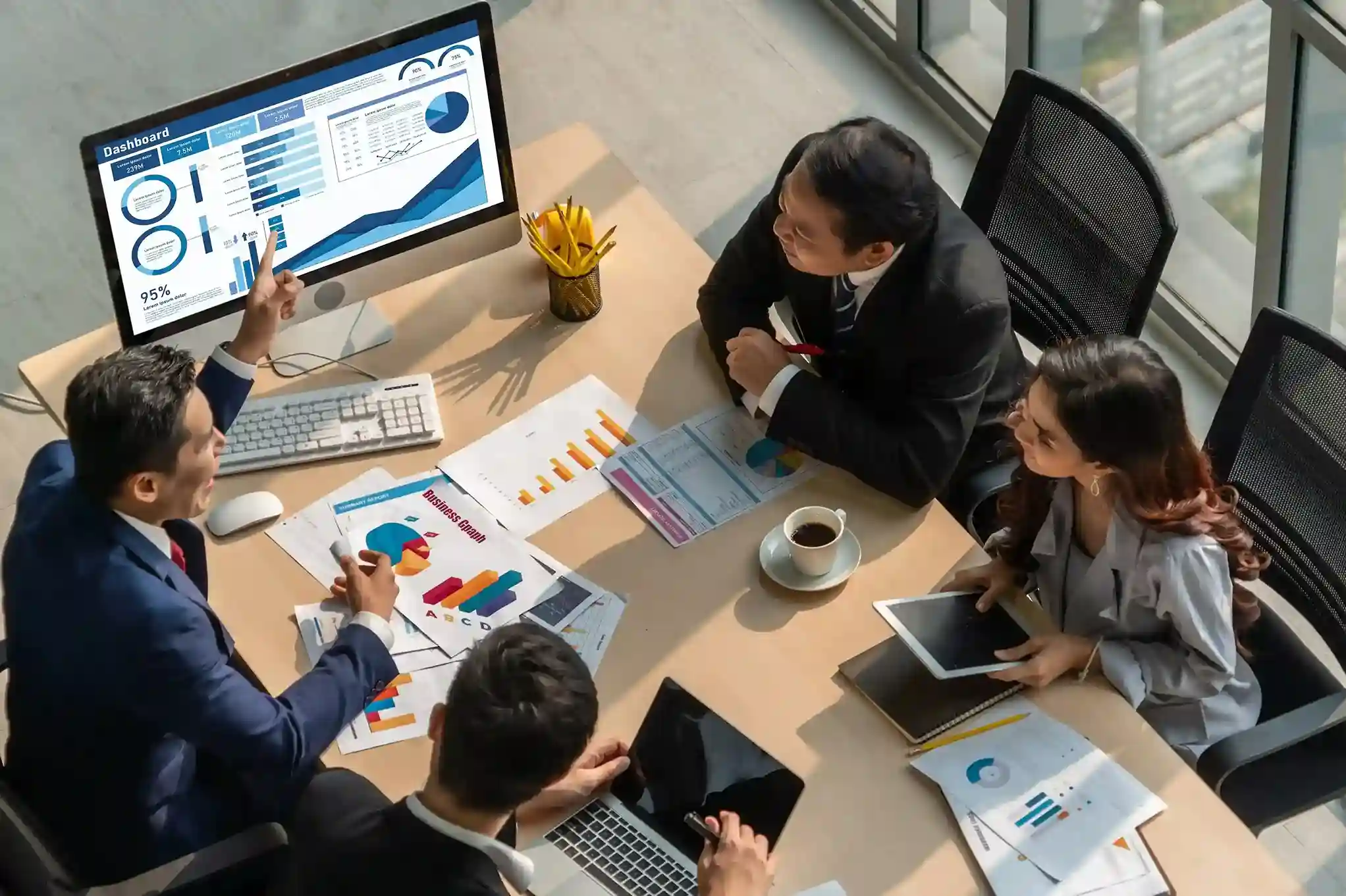 Enterprise professionals discussing API-driven data flow across CRM, ERP, and analytics platforms using Indosoft A business team reviewing BI dashboards and connected enterprise systems using Indosoft integrations.