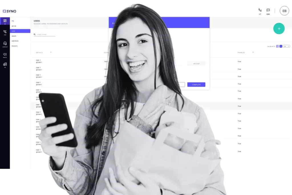 A call center manager smiles while reviewing her mobile device, as an AI-powered user management dashboard runs in the background, reflecting how Asterisk and AI integration simplify team oversight and intelligent call handling.